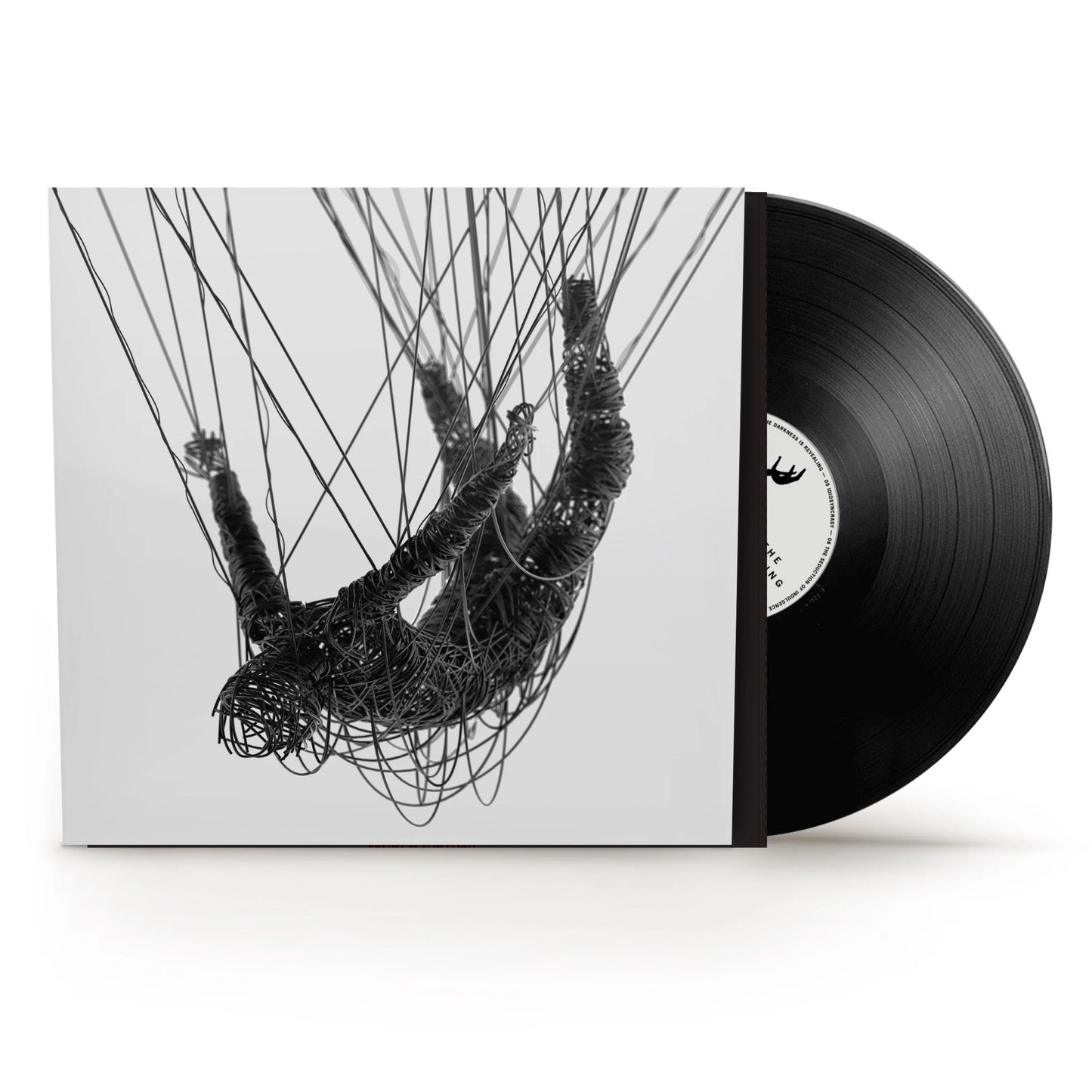 Korn - The Nothing Vinyl A vinyl record partially pulled from its sleeve, showing a black-and-white artwork of a hanging figure made of tangled wires on a light background. The record itself is black with a white center label.