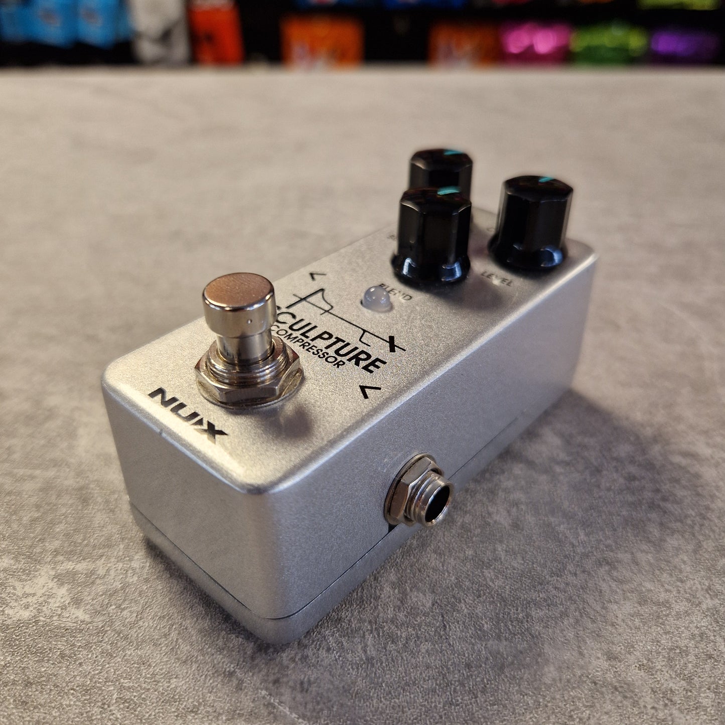 Nux Sculpture guitar effects pedal on a textured surface