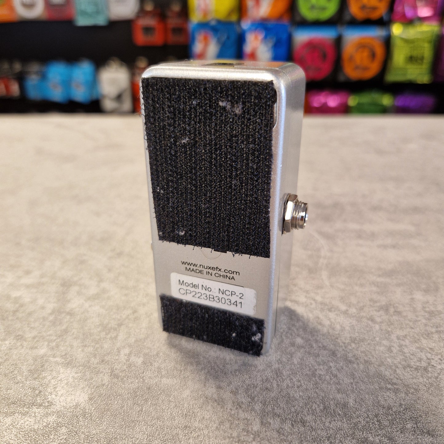 Nux NCP-2 with a black velco on a textured surface