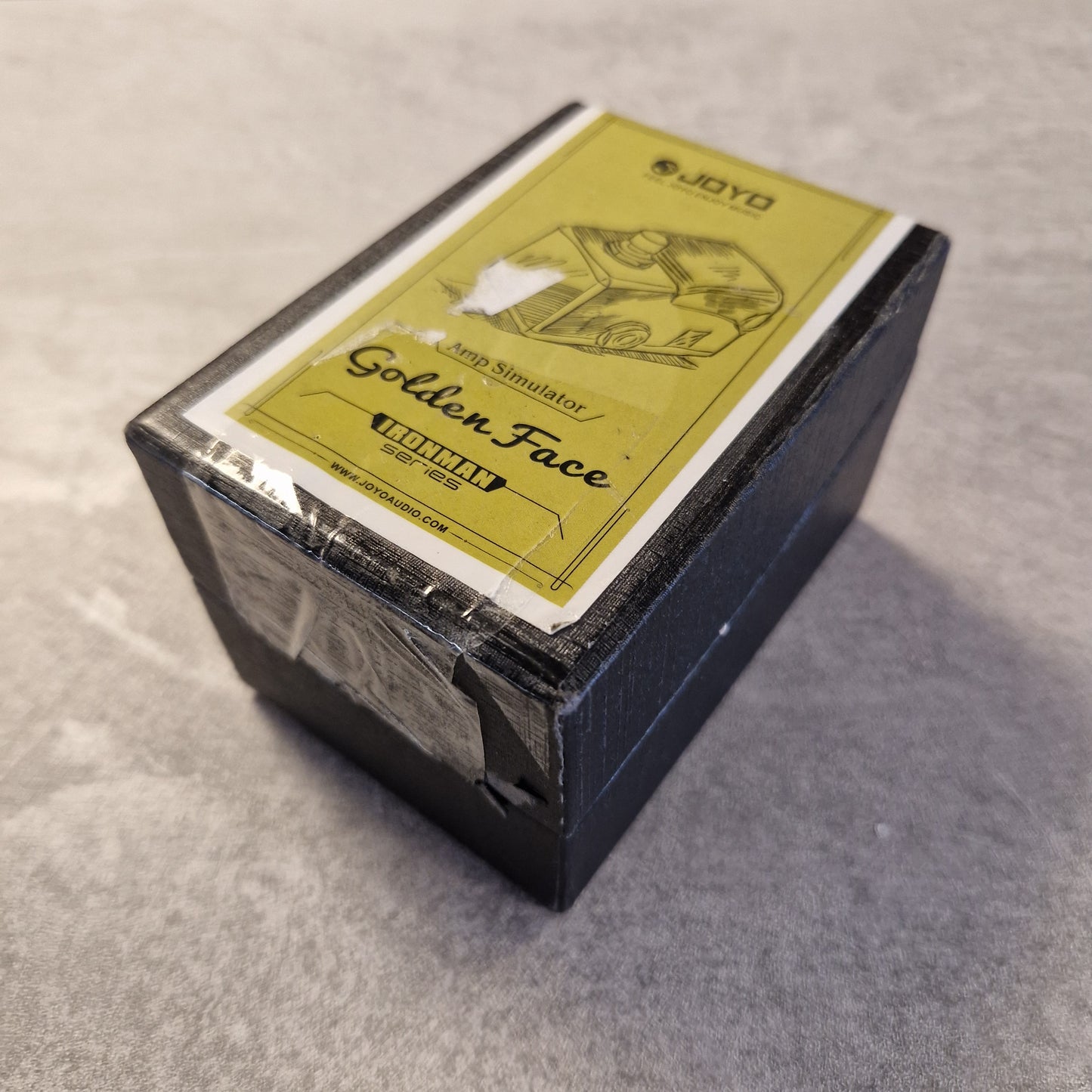 Joyo JF-308 with a yellow label on a grey surface
