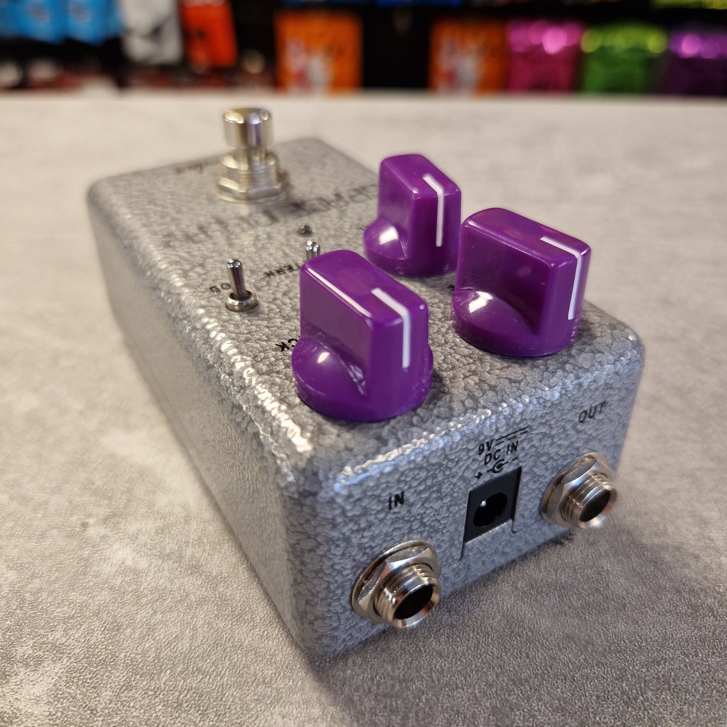 Fender Hammertone Space Delay Guitar effects pedal with purple knobs on a gray surface