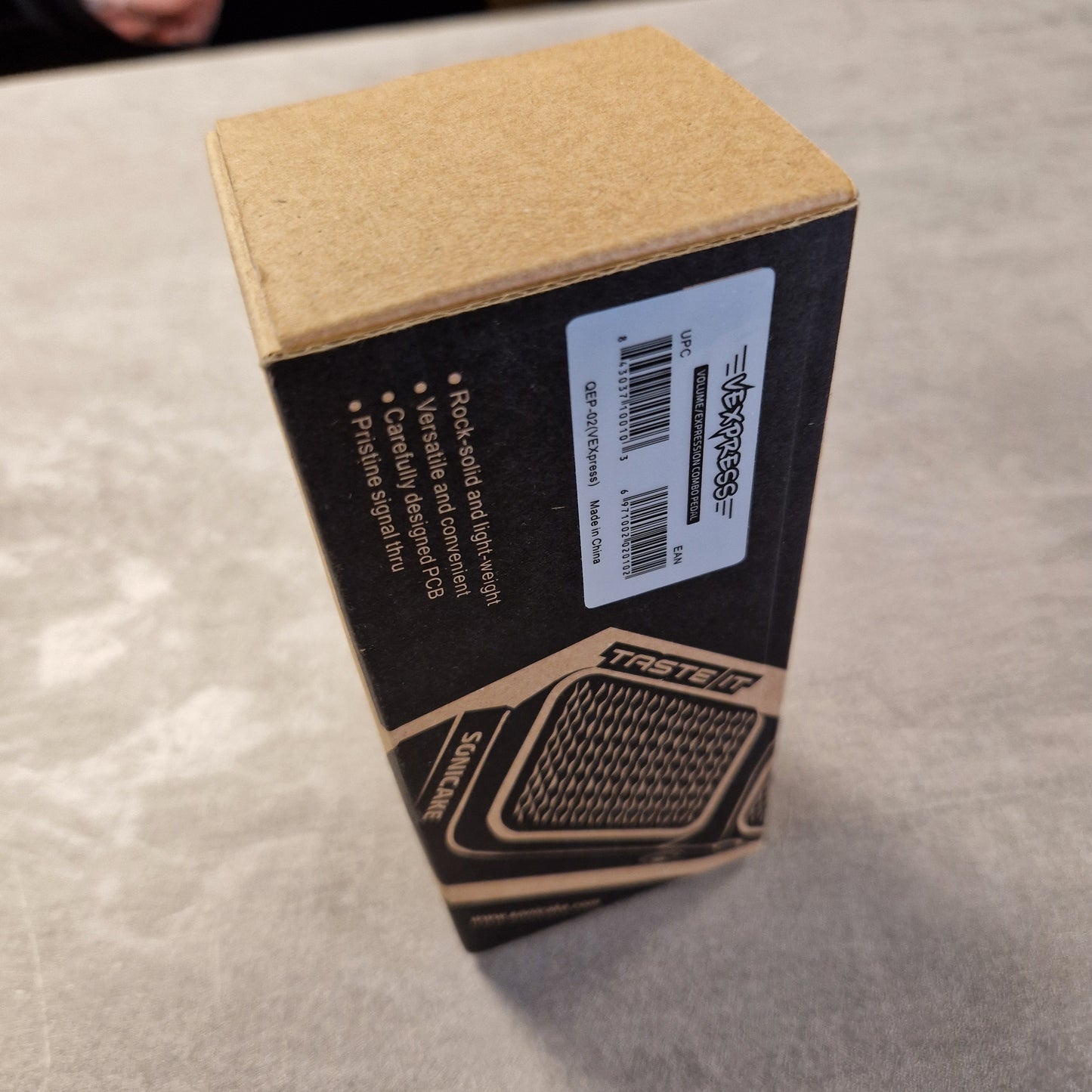 Pre-Owned Sonicake Product packaging with Vexpress branding on a textured surface