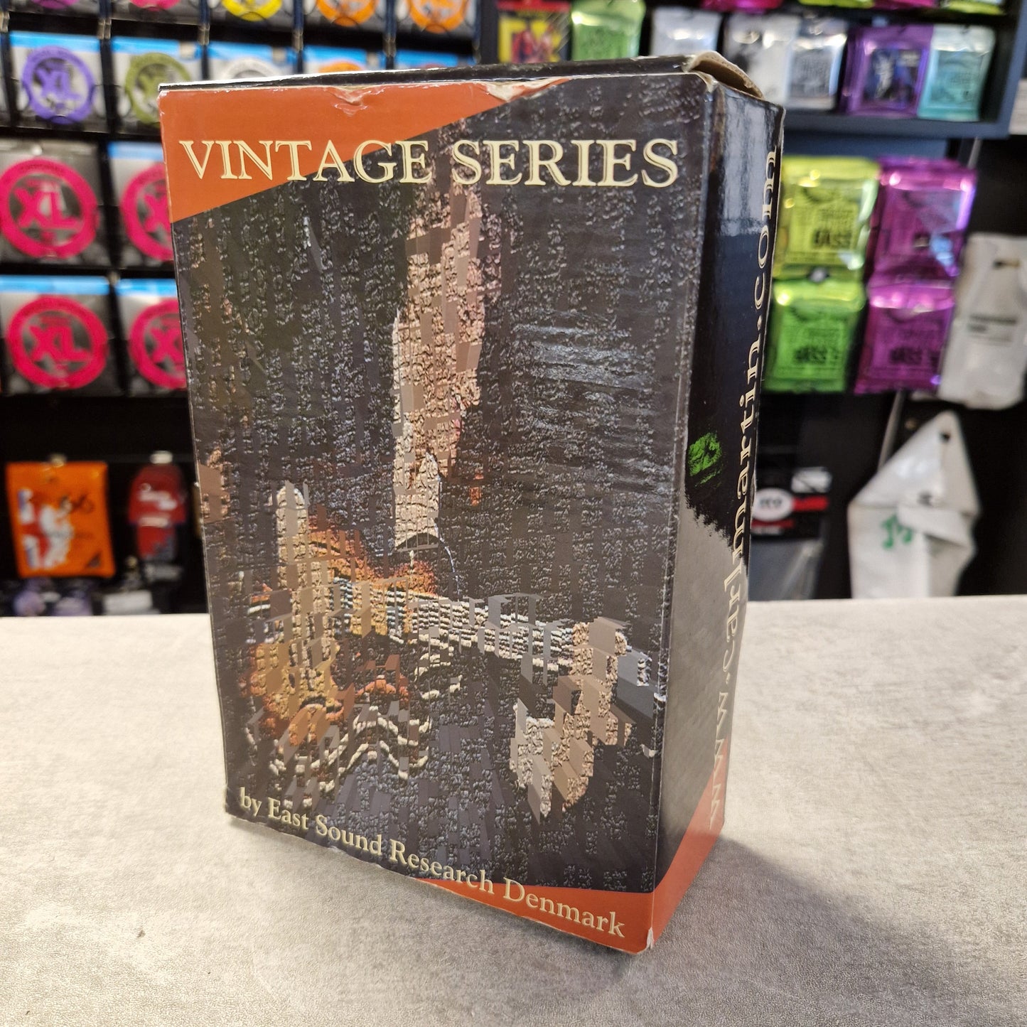 Pre-Owned Carl Martin Surf Trem Vintage book with a map design on a shelf with various items in the background