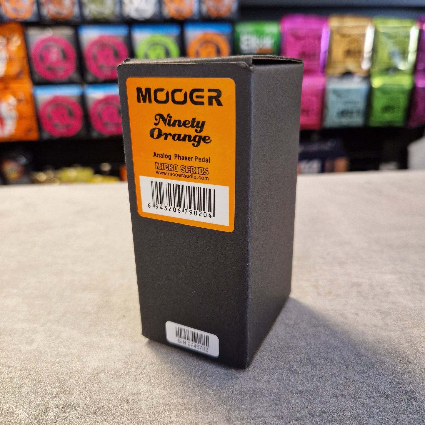 Pre-Owned Mooer MPH1 Black box with orange label featuring 'Mooer' brand on a gray surface.