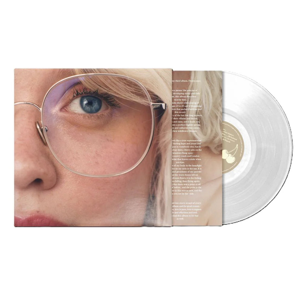 Maisie Peters - Florescence (Dandelion Edition Transparent EcoRecord) Vinyl Vinyl record with a cover featuring a close-up of a person's face wearing glasses.