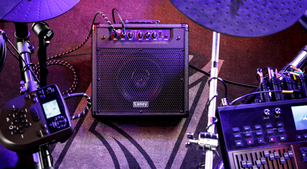 Laney DH40 Personal Drum Monitor 40w positioned among electronic drum kit components on a textured surface.
