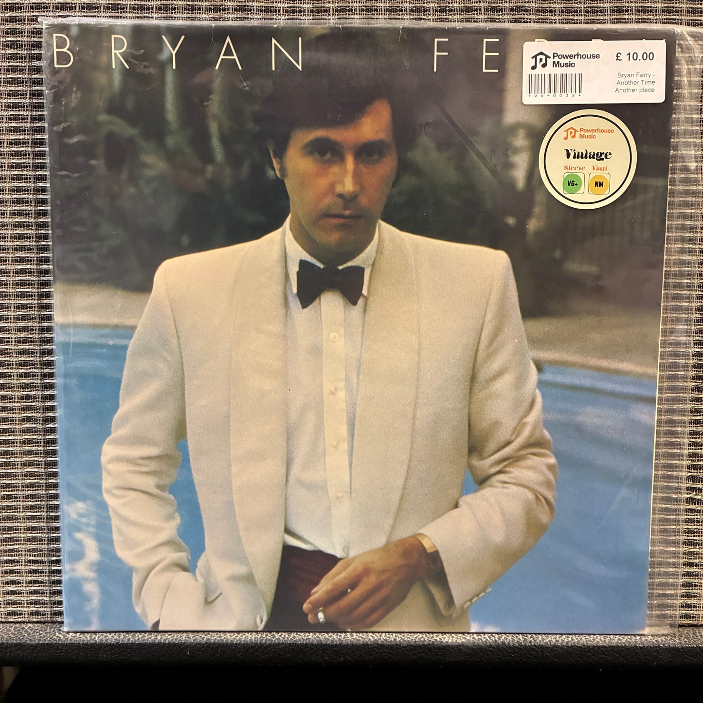 Bryan Ferry - Another Time Another Place Vinyl record cover featuring a man in a suit with a bow tie, set against a natural background.