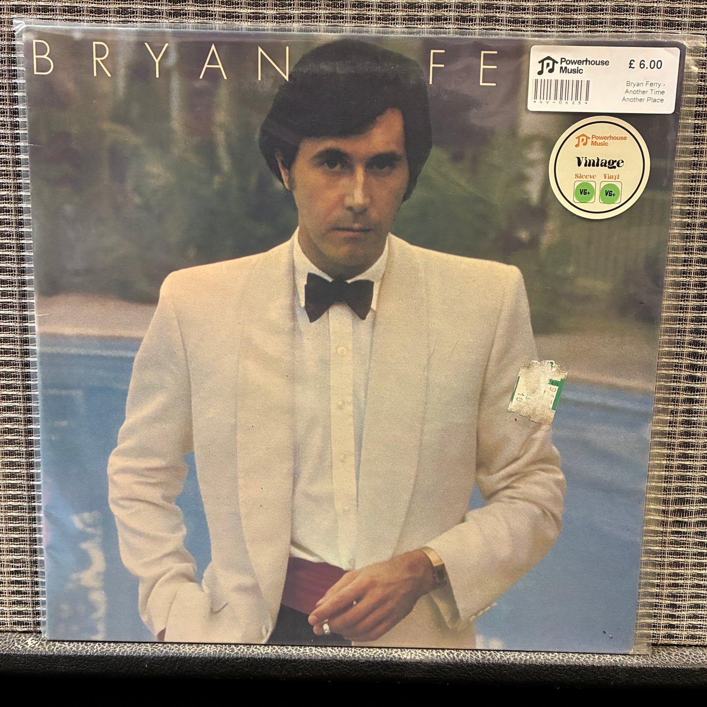 Bryan Ferry - Another Time Another Place Vinyl record cover with a person in formal attire, featuring a pool and garden background.