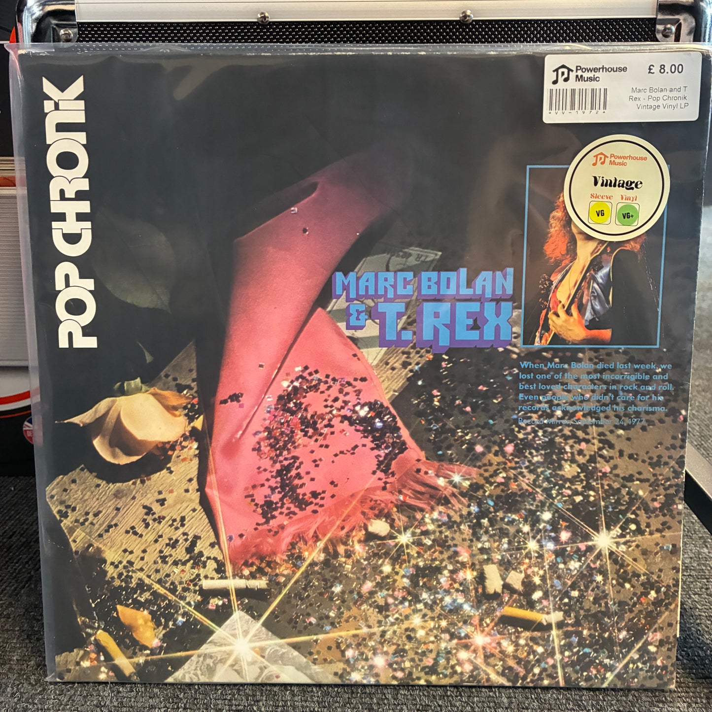 Marc Bolan and T. Rex - Pop Chronik Vintage Vinyl LP A vinyl record album cover for Marc Bolian & T. Rex's 'Pop Chronic' is shown in its shrink wrap on a black equipment case.