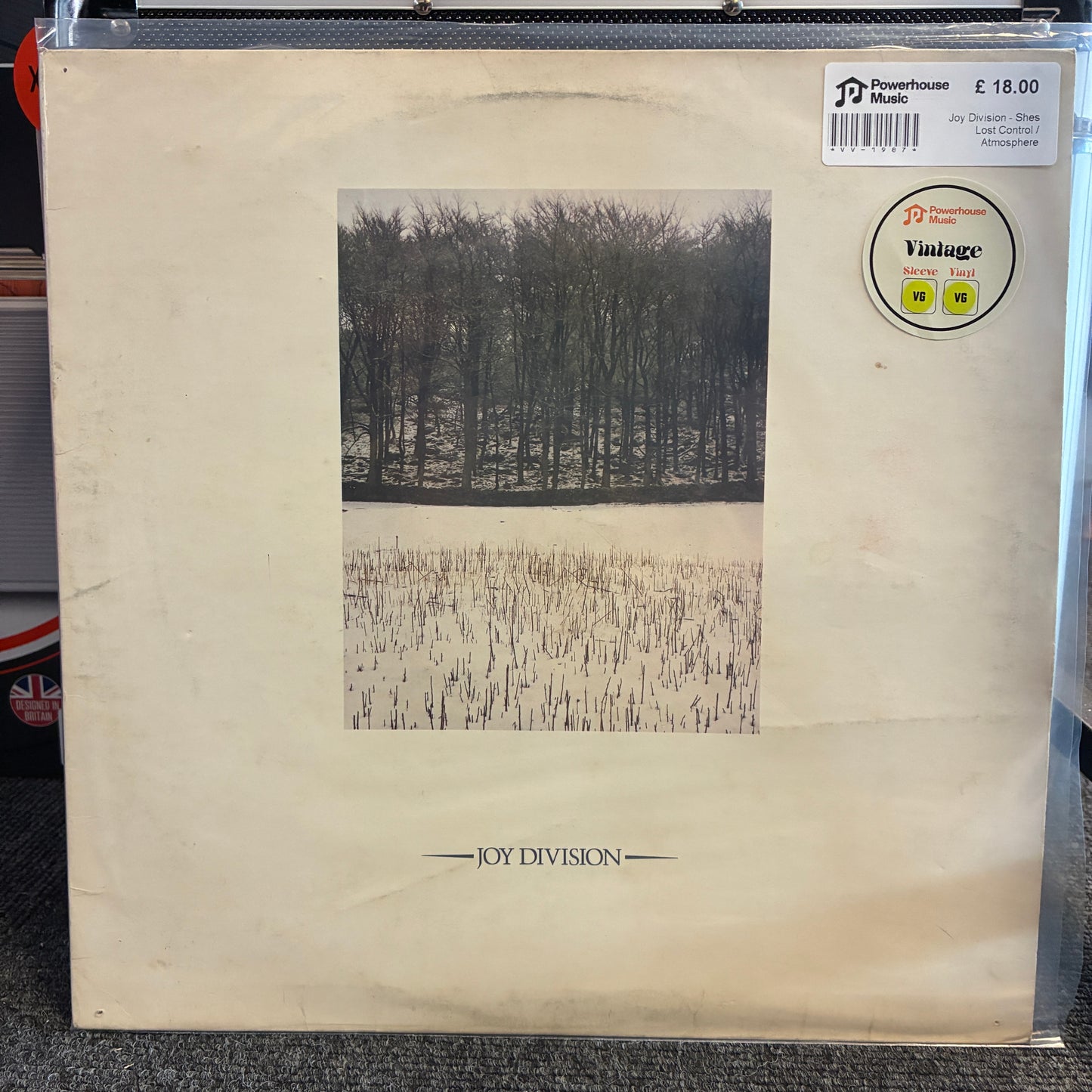 Joy Division - Shes Lost Control / Atmosphere Vintage Vinyl 12" Single Vintage Joy Division 'Parachute' vinyl record sleeve in cream-colored paper, featuring a black and white forest photograph. Includes a 'Vintage' sticker and a 'JD Music' barcode sticker.