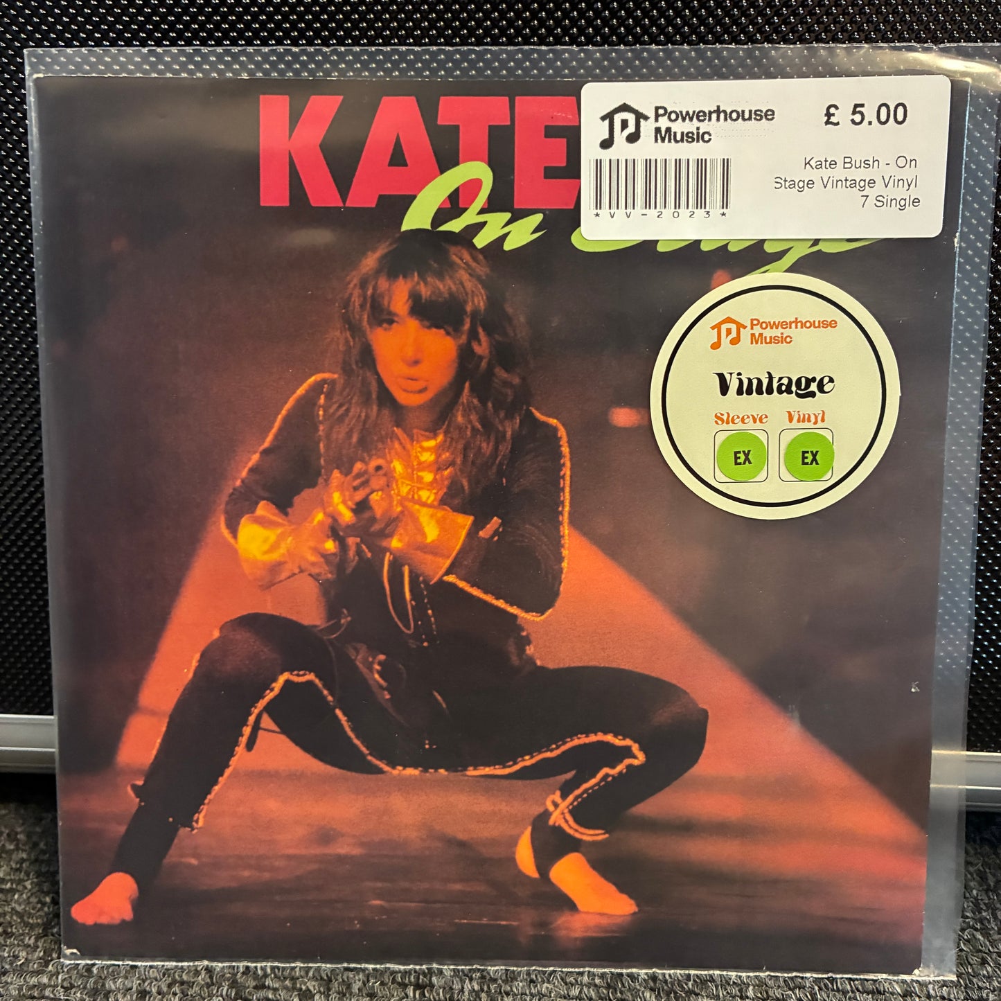 Kate Bush - On Stage Vintage Vinyl 7" EP Vintage Kate Bush 'On Stage' 7-inch vinyl single sleeve on a clear protective plastic case, with a white Powerhouse Music sticker showing the price and a circular 'Vintage Sleeves' label.