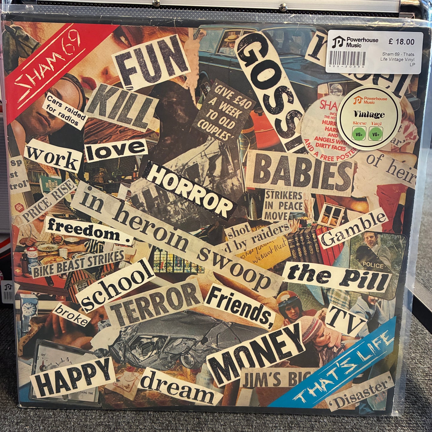 Sham 69 - Thats Life Vintage Vinyl LP A square vinyl record sleeve for Sham 7's 'Gossip' album, featuring a dense collage of torn newspaper-style papers with words and phrases like 'FUN', 'KILL', 'GOSSIP', 'BABES', 'MONEY', and 'HAPPY'. A Powerhouse label sticker is visible in the top right corner.