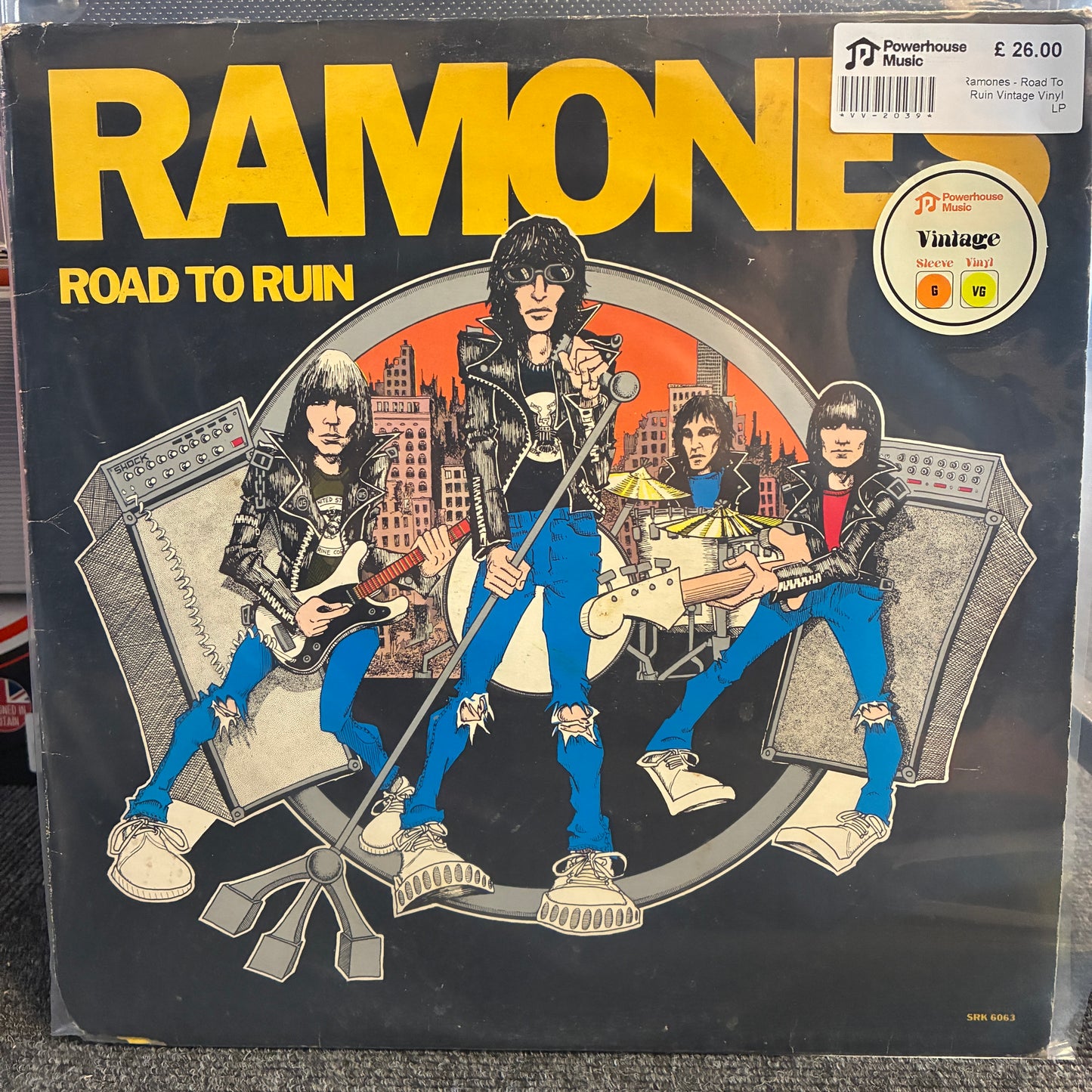 Ramones - Road To Ruin Vintage Vinyl LP Ramone 'Road to Ruin' vinyl record album cover, showing illustrated band members with guitars and drums against a dark background, with large yellow RAMONE text at the top and a circular 'Vintage' sticker in the upper right.