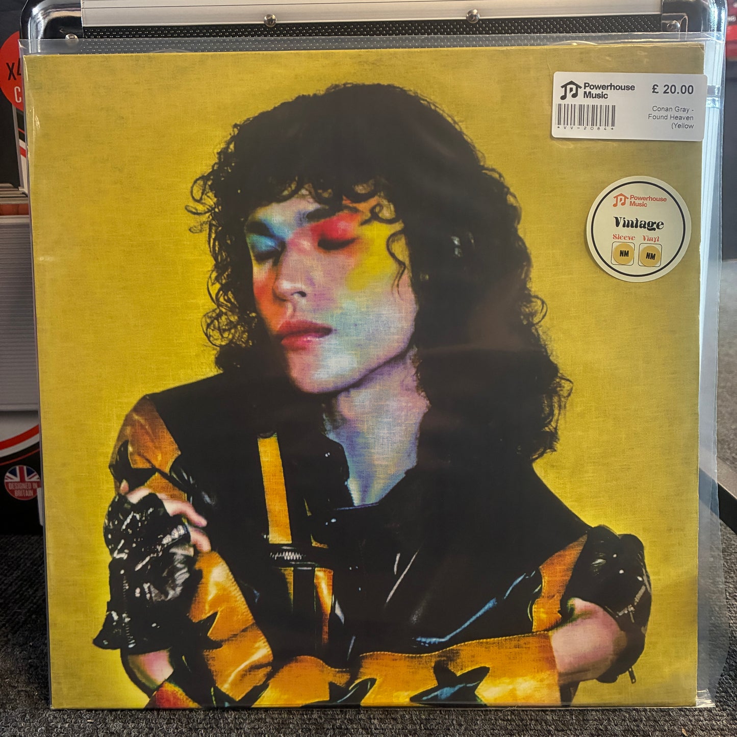 Conan Gray - Found Heaven (Yellow Translucent) Vintage Vinyl LP A vinyl record sleeve for Jim Morrison's 'Rumours' on a black case, displayed in a record store. The cover features a stylized portrait of Jim Morrison with colorful eye makeup against a yellow background, with a 'JJ Recordstore' price sticker and 'Vintage Vinyl' sticker on the top right.