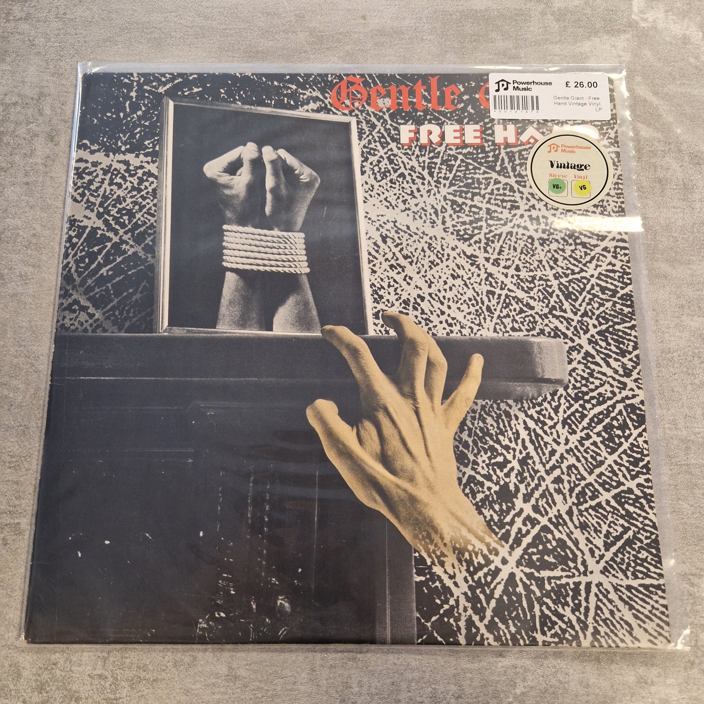 Gentle Giant - Free Hand Vintage Vinyl LP Gentle Monster's 'Free' 12-inch vinyl record LP, sealed in its original plastic shrink wrap. The album cover features a black and white background with a hand reaching out from a dark box, and the title 'Gentle i FREE' in red and white text.