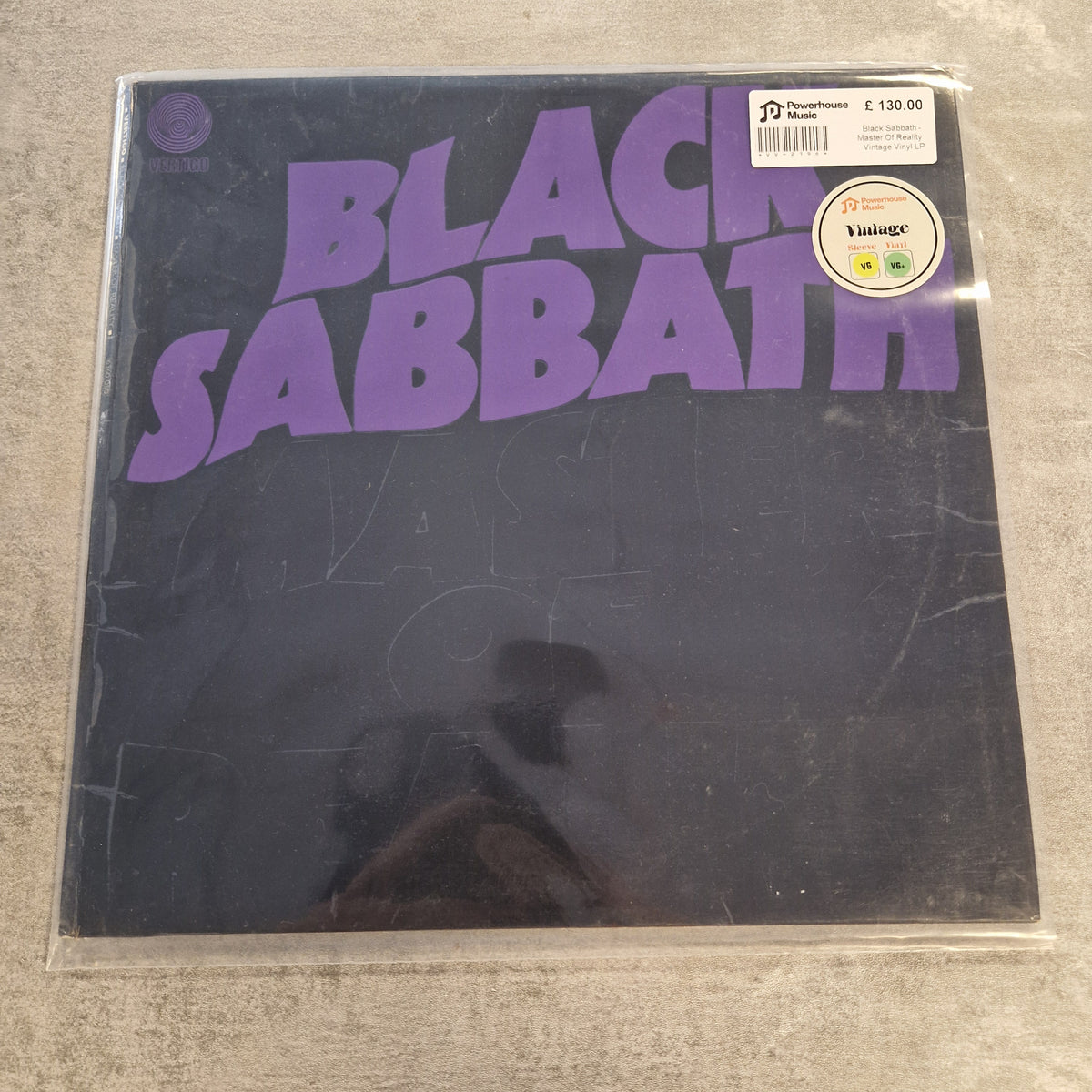 Black Sabbath - Master Of Reality Vintage Vinyl LP A sealed vinyl record of Black Sabbath on a dark background, with large purple 'BLACK SABBATH' lettering and a small 'Yage' sticker on the top right.