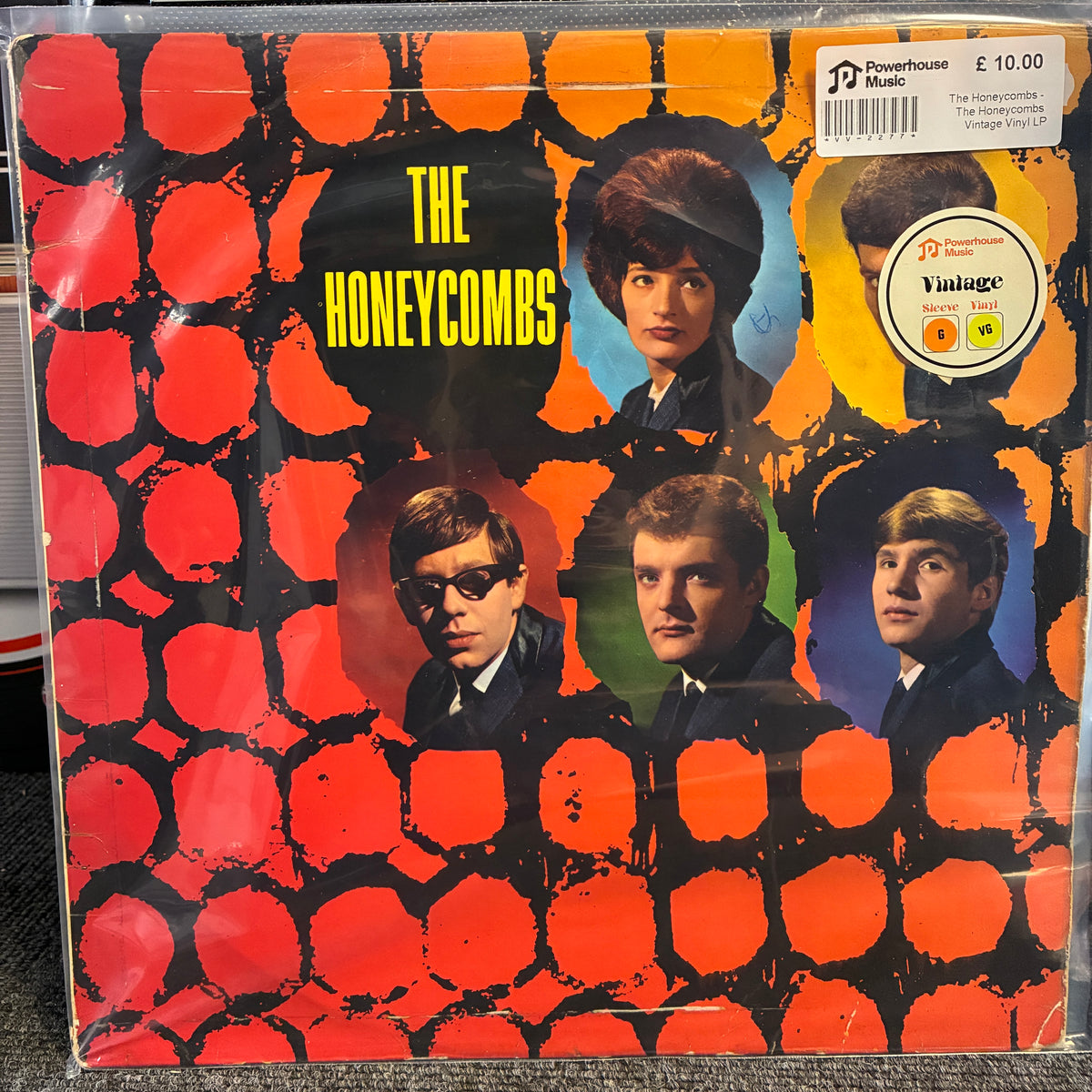 The Honeycombs - The Honeycombs Vintage Vinyl LP The Honeycombs vinyl record album 'The Honeycombs' on Powerhouse Records, featuring a vibrant orange and black honeycomb pattern with portraits of the band members. A Powerhouse 'Vintage' sticker is visible in the top right corner.