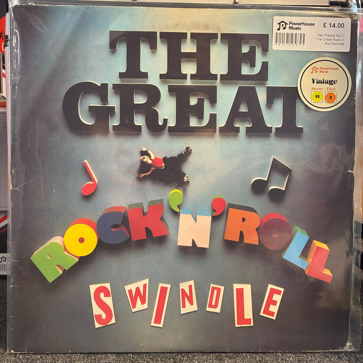 Sex Pistols - The Great Rock 'N' Roll Swindle Vintage Vinyl LP The Great Rock 'N' Roll Swindle vinyl record album cover, sealed in a clear plastic sleeve. The cover features bold 3D lettering with musical notes and a small figure of a man falling, set against a blue-gray background.