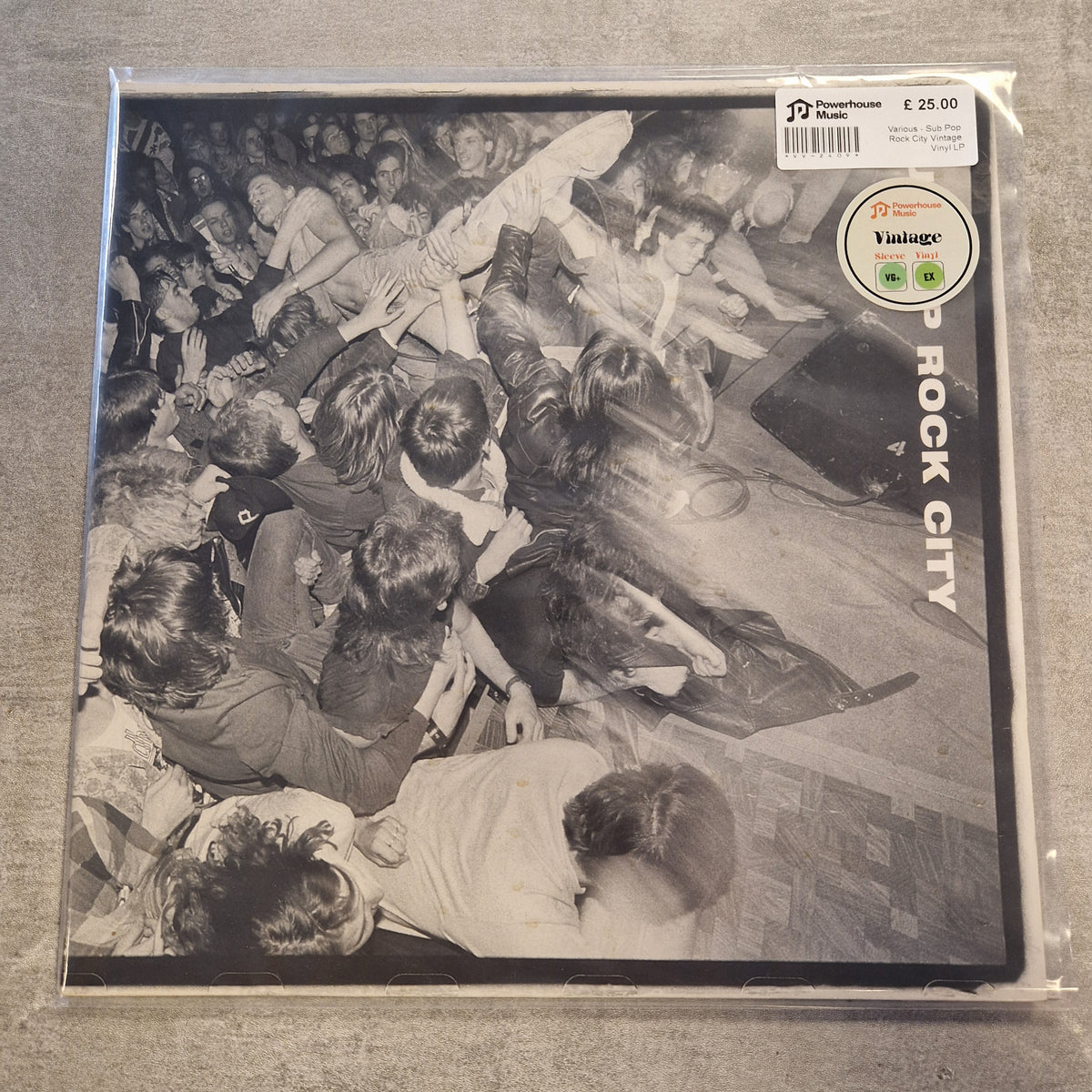 Various - Sub Pop Rock City Vintage Vinyl LP A vinyl record sleeve for the band Rock City, featuring a black and white photograph of a crowd. The sleeve is sealed in its original plastic shrink-wrap with a 'Vintage' seller sticker and a barcode price label in the top right corner.
