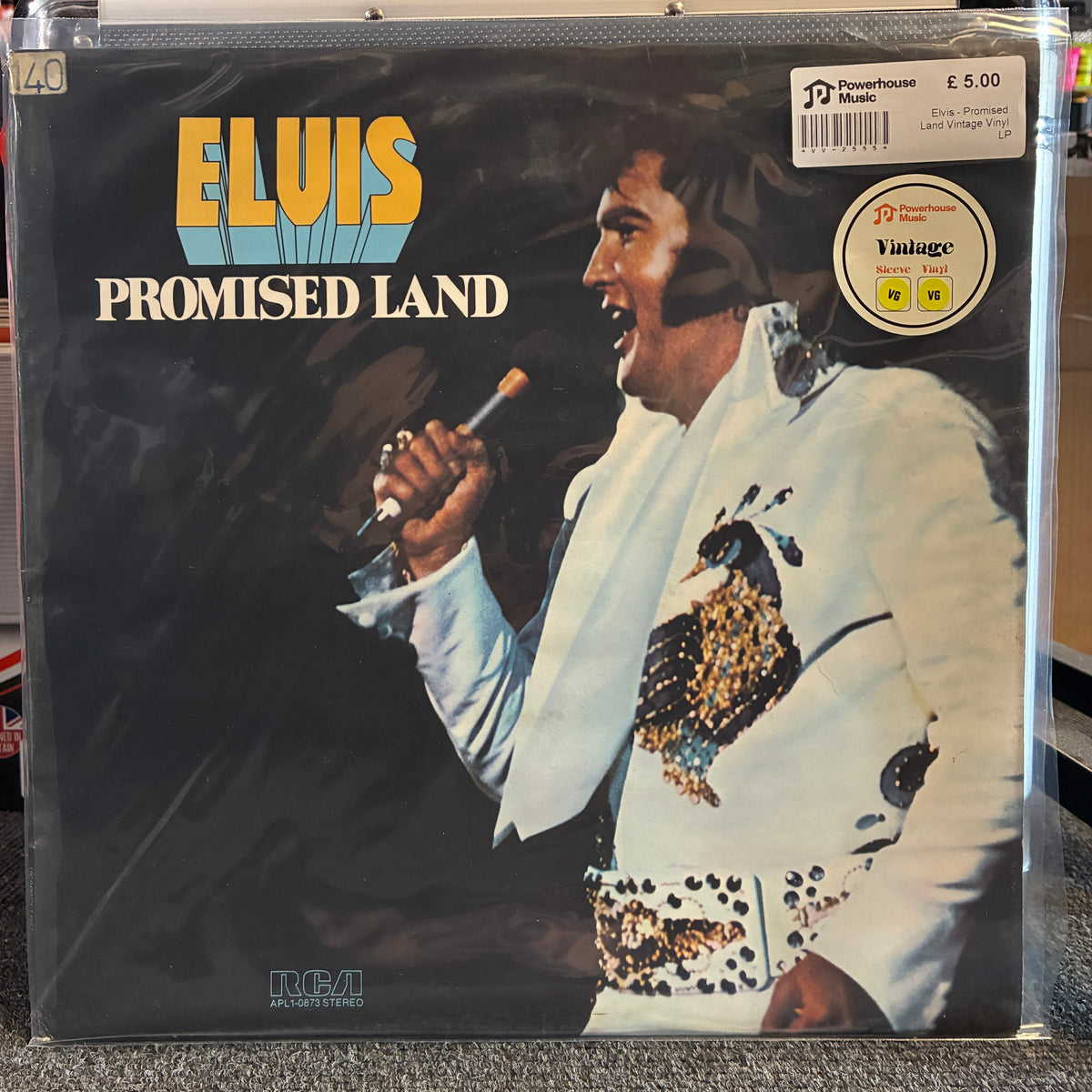 Elvis - Promised Land Vintage Vinyl LP Elvis 'Promised Land' vinyl record album in a clear plastic protective sleeve, showing the cover art with Elvis in a white sequined jacket against a dark background.