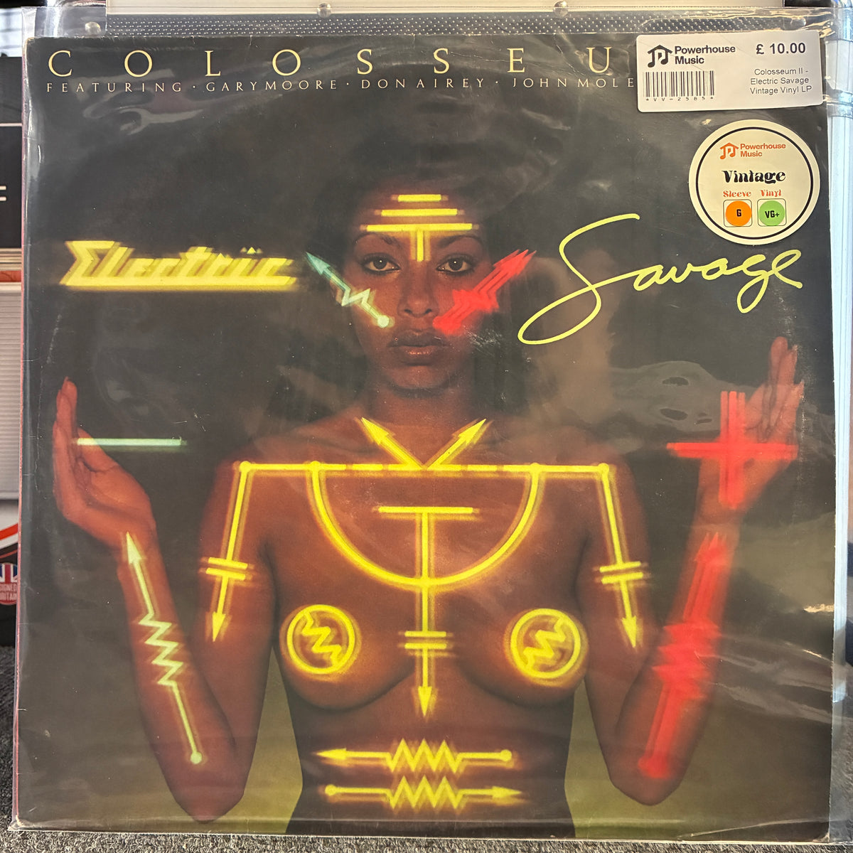 Colosseum II - Electric Savage Vintage Vinyl LP Colosseum 'Savage' vinyl record sleeve, featuring a stylized portrait of a woman with neon yellow, red, and green graphic overlays on a dark background. Includes a P1000 Records barcode sticker and a Vintage Vinyl sticker.