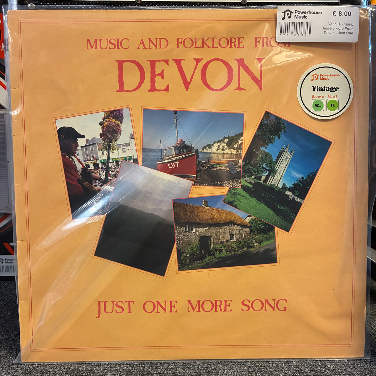 Various - Music And Folklore From Devon - Just One More Song Vintage Vinyl LP A vinyl record album cover for 'Music and Folklore from Devon - Just One More Song' on a warm orange background, featuring five inset photographs of Devon landscapes and people. The record is still sealed in plastic shrink-wrap, with a barcode sticker and a 'Vintage' label visible on the cover.