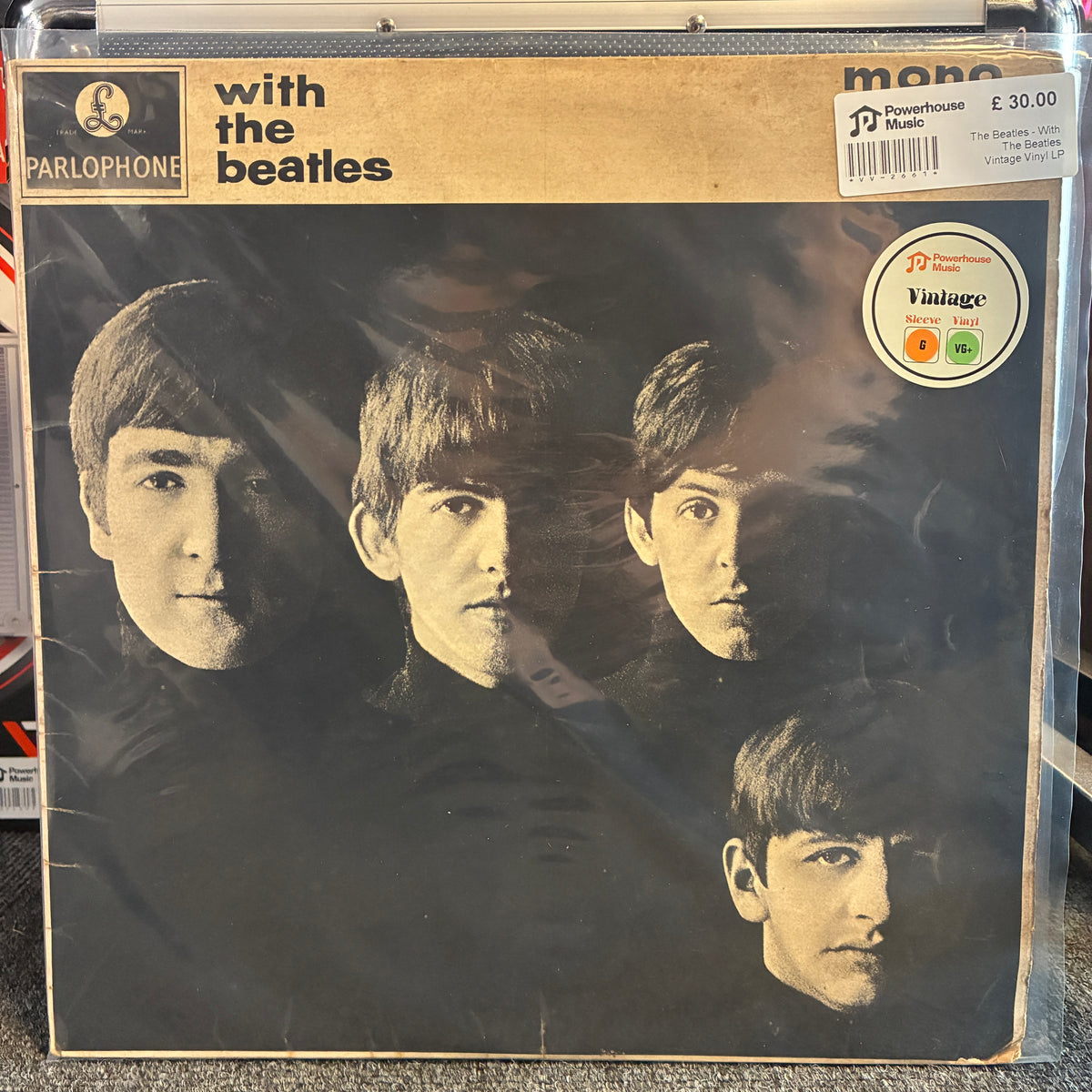 The Beatles - With The Beatles Vintage Vinyl LP A vintage Parlophone 'with the Beatles' mono record sleeve, showing the band members' faces on the cover, photographed in a clear plastic protective case. The cover has a tan header with black text and a black-and-brown portrait photo.