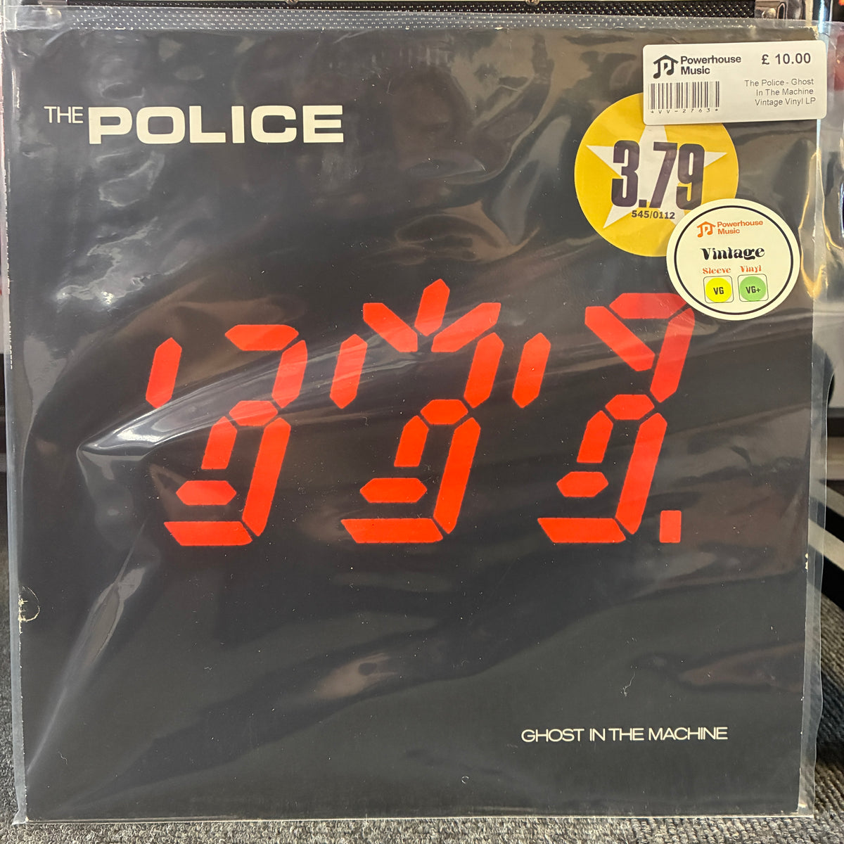 The Police - Ghost In The Machine Vintage Vinyl LP The Police 'Ghost in the Machine' vinyl record cover in its original shrink wrap, featuring a black background with a large red LED-style number display and white band logo text.