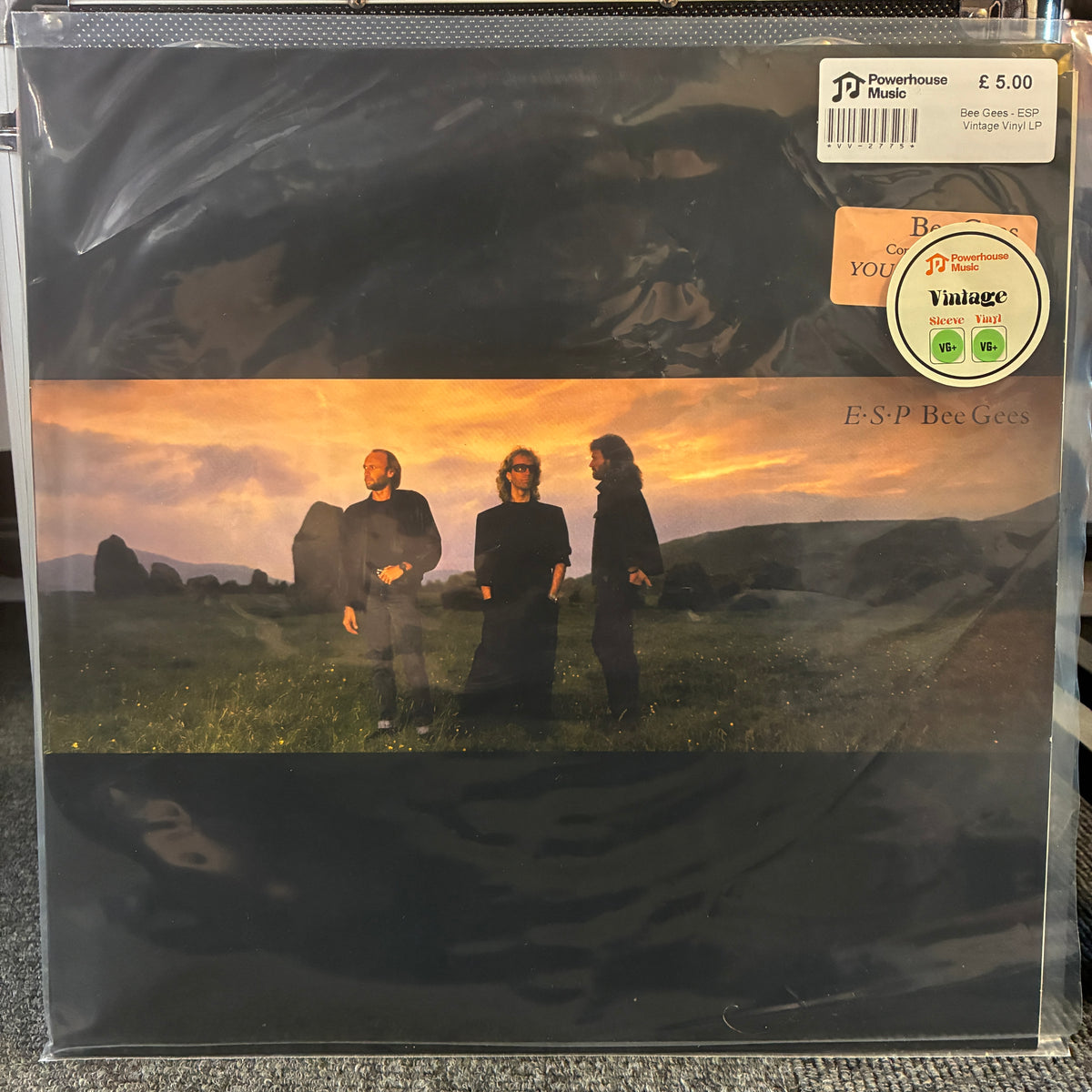 Bee Gees - ESP Vintage Vinyl LP ESP Bee Gees vinyl record album in its original shrink wrap, featuring the band members standing in a field at sunset. A white and orange B&O Records sticker is visible in the top right corner.