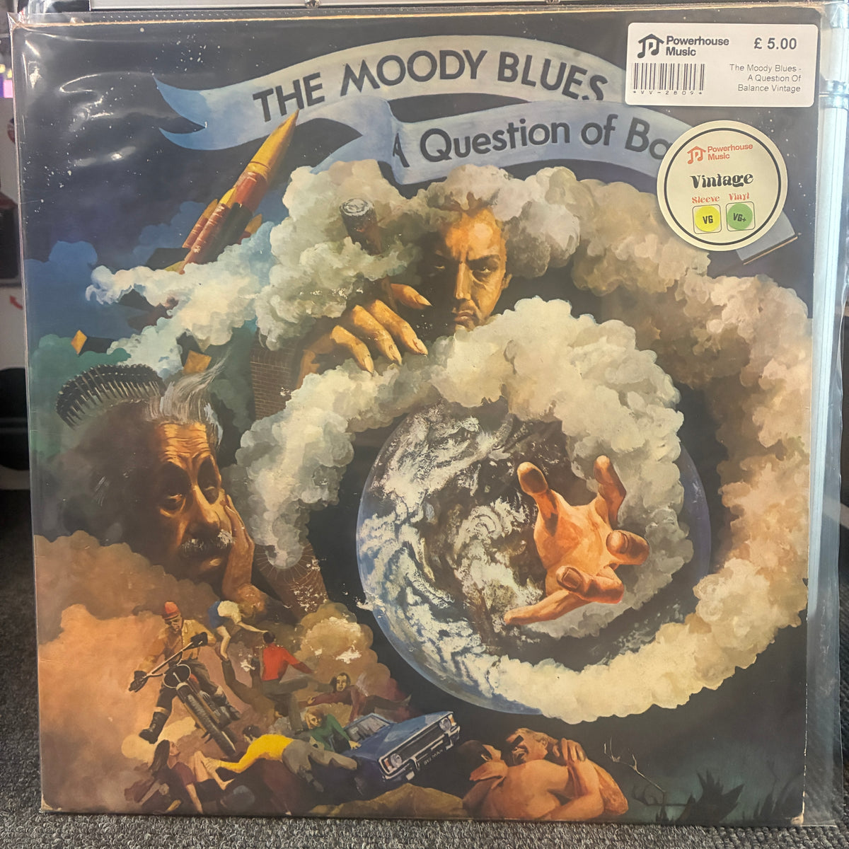 The Moody Blues - A Question Of Balance Vintage Vinyl LP The Moody Blues 'A Question of Beauty' vinyl record album in its original shrink wrap, featuring the band's iconic surreal album artwork with a central globe and a stormy sky. A Powerhouse Music logo and a Vintage Records sticker are visible on the packaging.