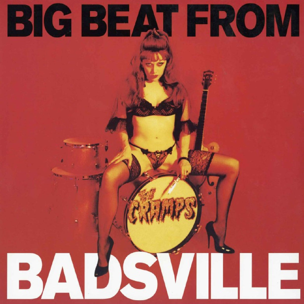The Cramps - Big Beat From Badsville Vinyl Album cover art for 'Big Beat From Badsville' by The Cramps, featuring a woman seated on a drum kit against a solid red background with bold black and white text.