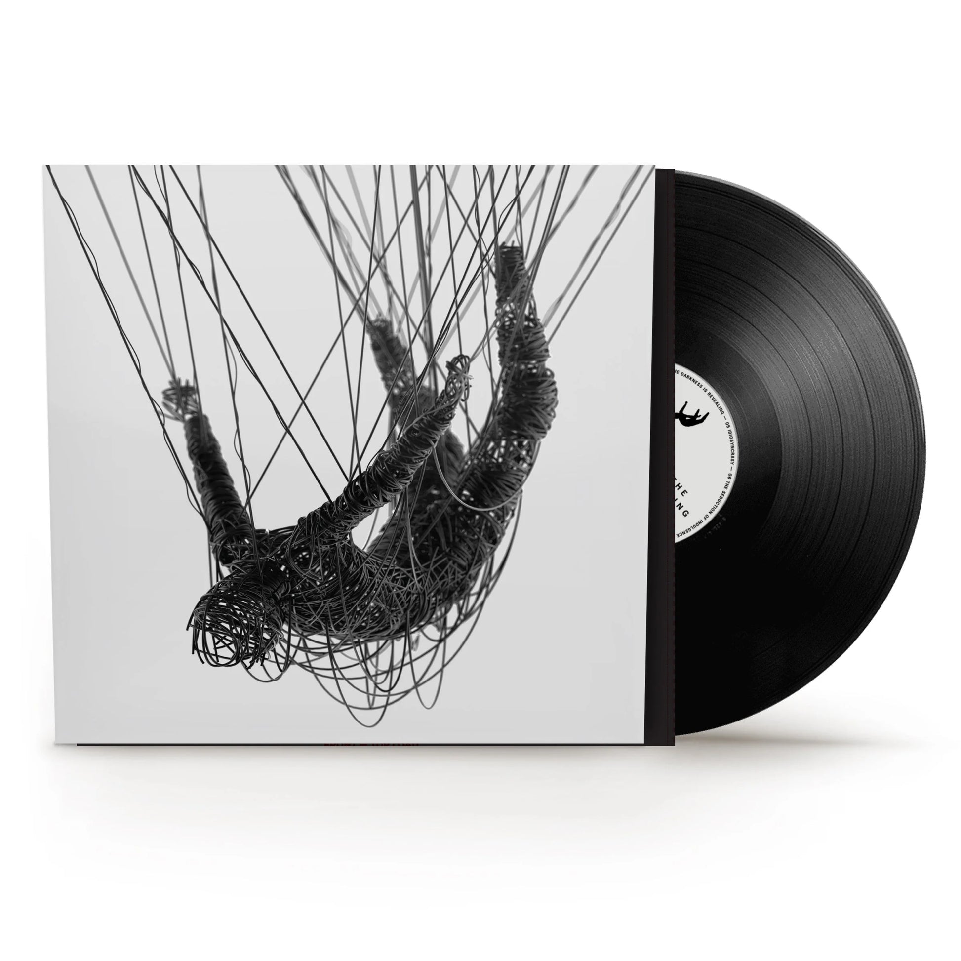 Korn - The Nothing Vinyl A vinyl record partially pulled from its sleeve, showing a black-and-white artwork of a hanging figure made of tangled wires on a light background. The record itself is black with a white center label.