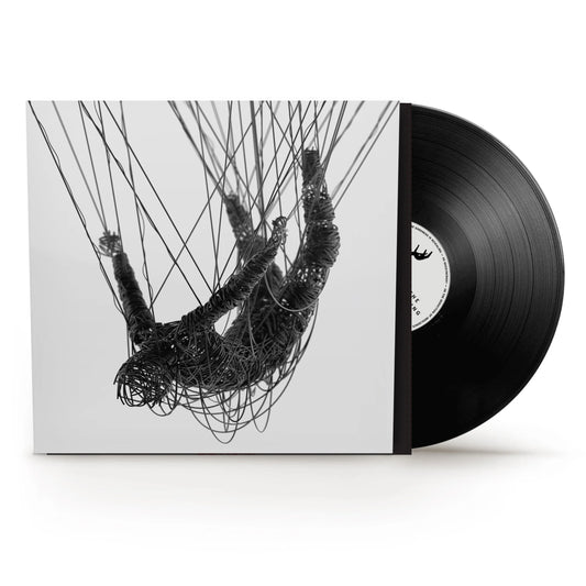 Korn - The Nothing Vinyl A vinyl record partially pulled from its sleeve, showing a black-and-white artwork of a hanging figure made of tangled wires on a light background. The record itself is black with a white center label.