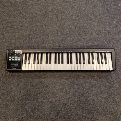 Roland A-49 MIDI Keyboard Mini keyboard on a textured gray surface