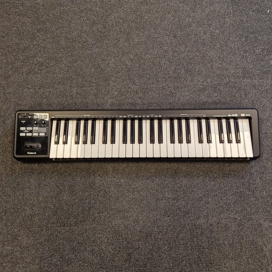 Roland A-49 MIDI Keyboard Mini keyboard on a textured gray surface