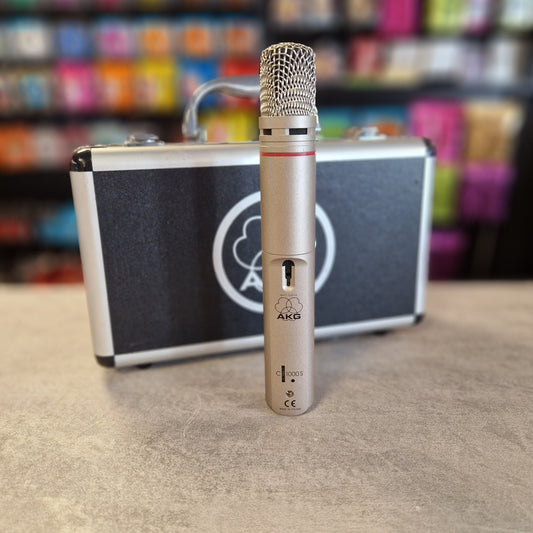 AKG C1000S  Microphone with a case on a textured surface with colorful background