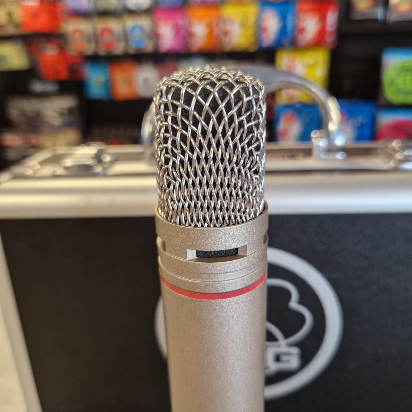 AKG C1000S  Microphone with a blurred background of colorful boxes
