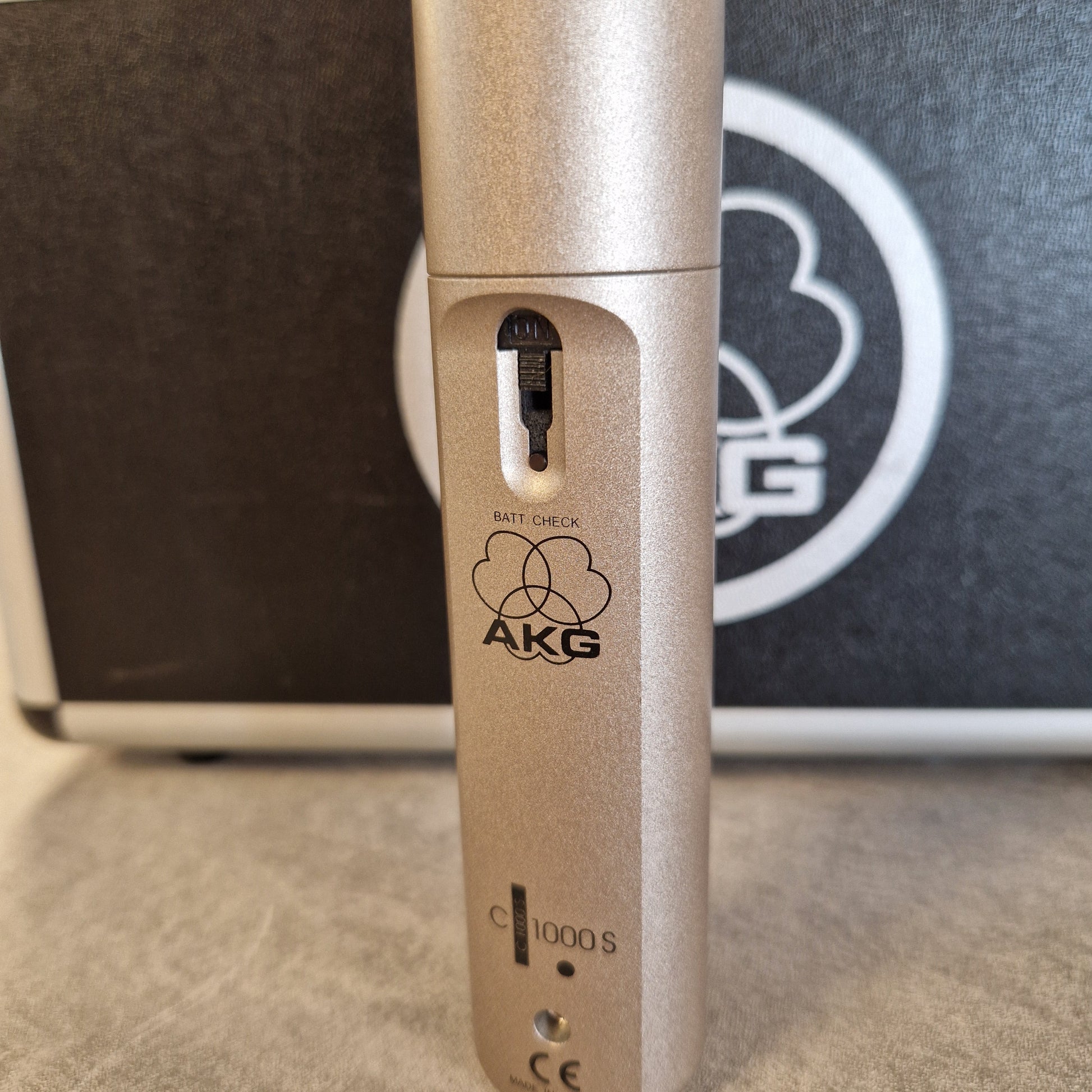 AKG C1000S  Close-up of a gold AKG microphone with a blurred background