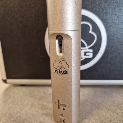 AKG C1000S  Close-up of a gold AKG microphone with a blurred background