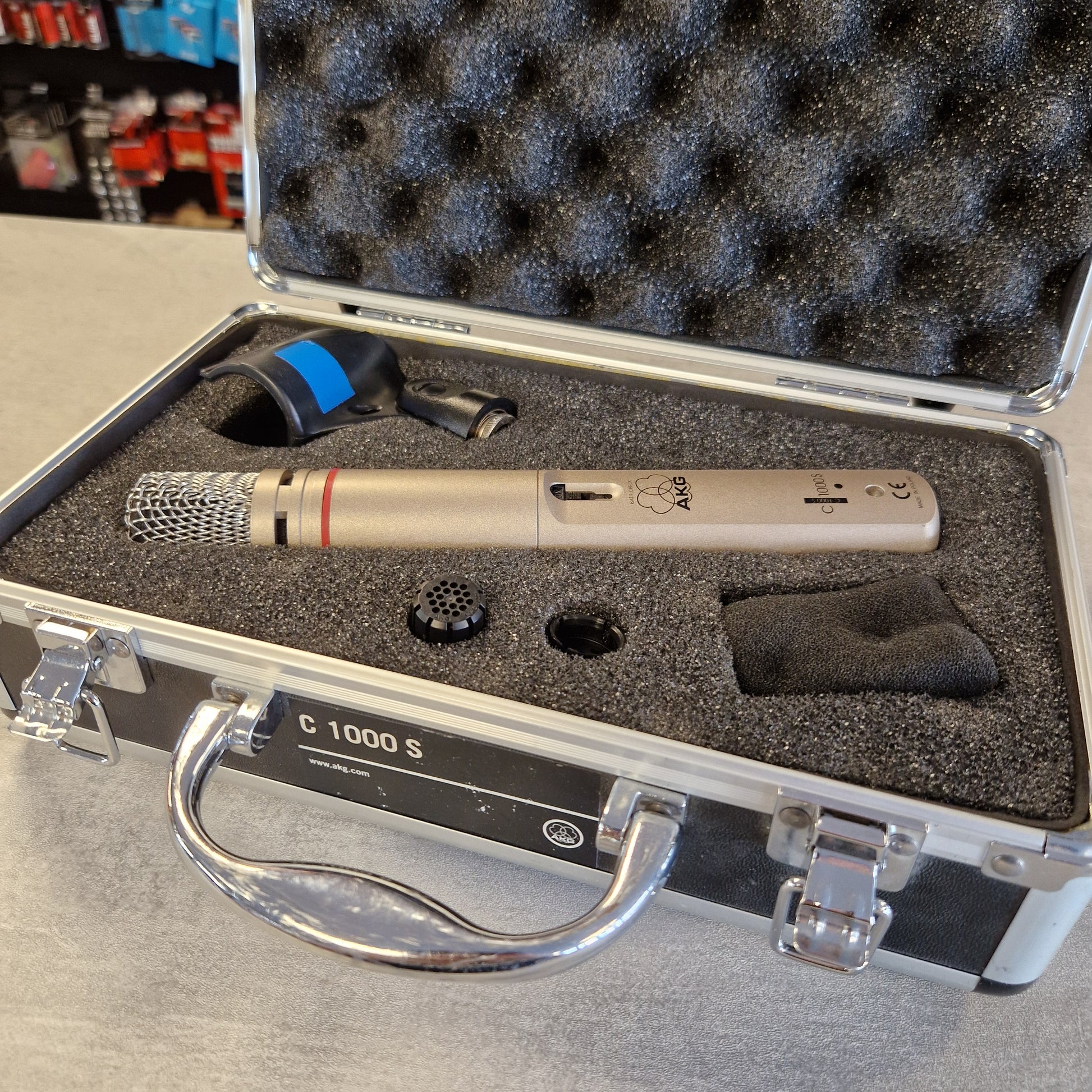 AKG C1000S  Microphone in a protective case on a gray surface