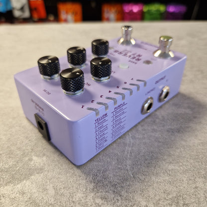 Mooer R7 X2 Purple audio effects pedal with knobs on a gray surface