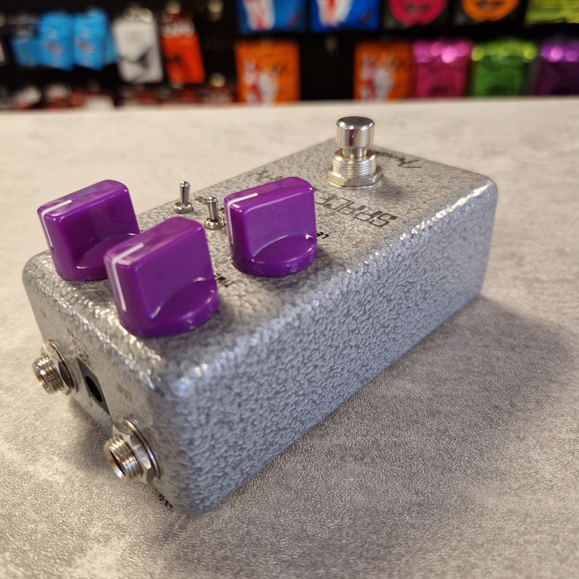 Fender Hammertone Space Delay Guitar effects pedal with purple knobs on a gray background