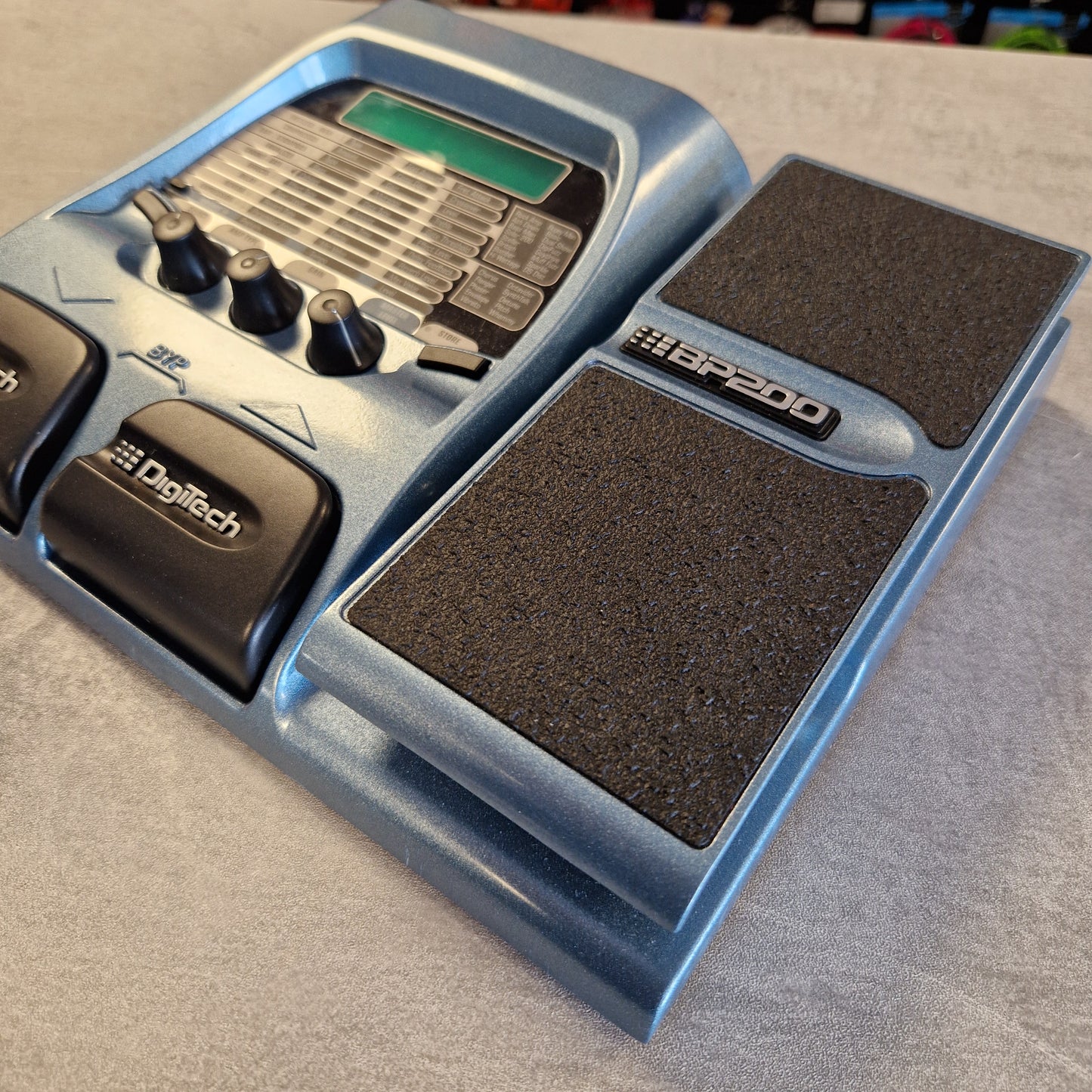 Pedal board with multiple pedals on a grey surface