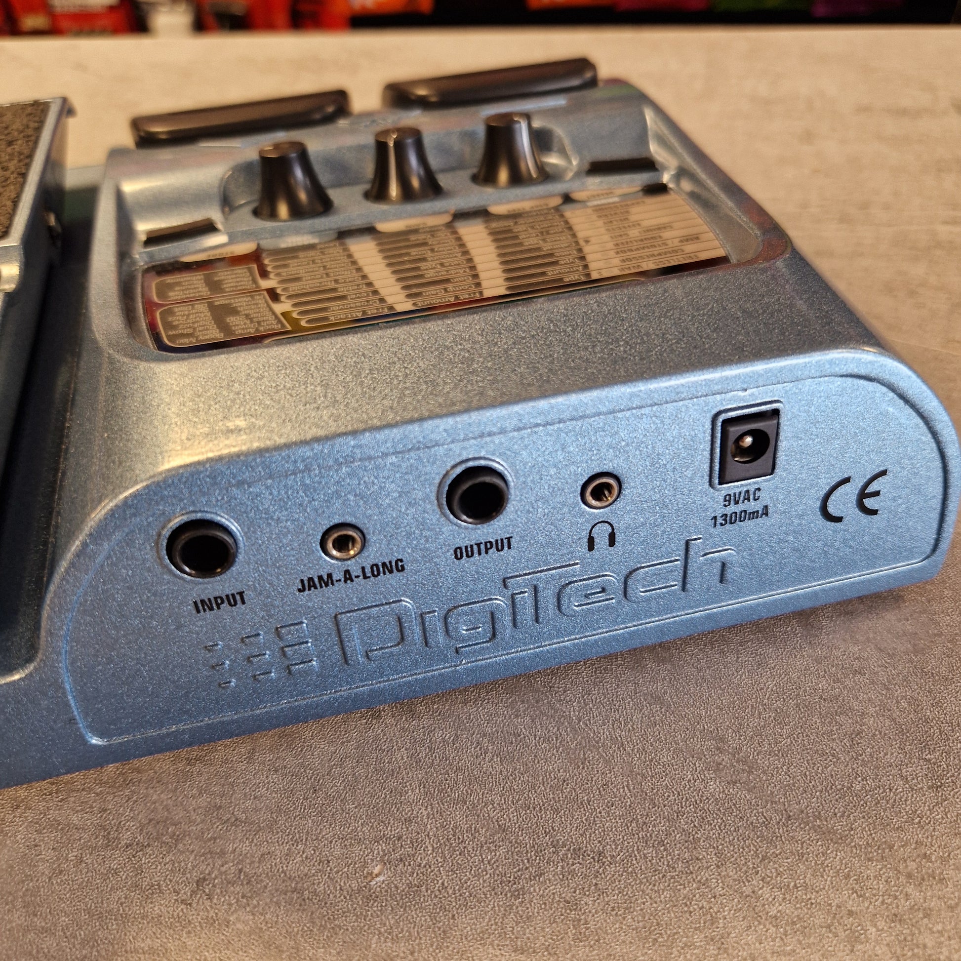 Back view of a DigiTech BP200 audio device with connectors and labels on a textured surface.