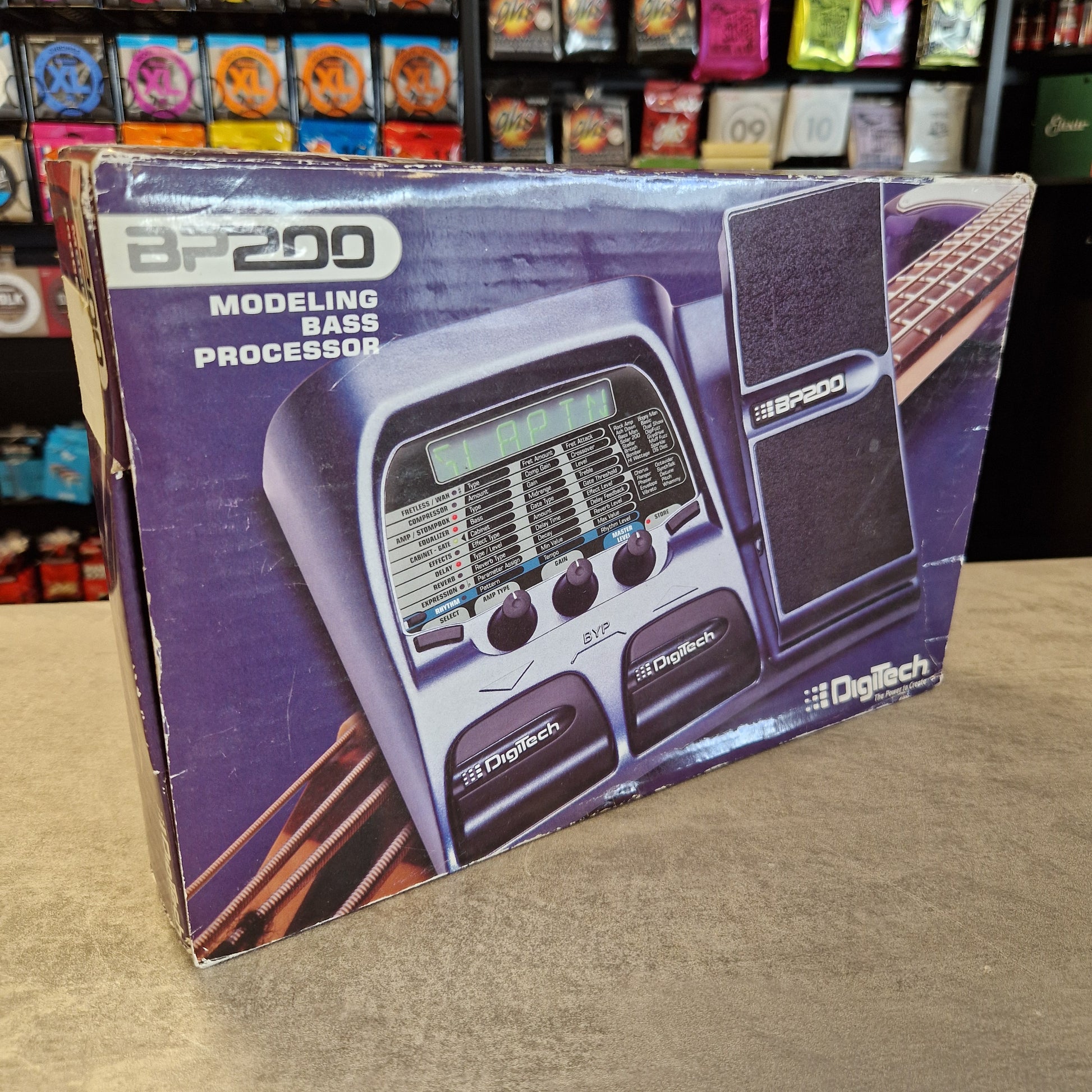 Boxed Digitech BP200 Modeling Bass Processor on a shelf with other items.
