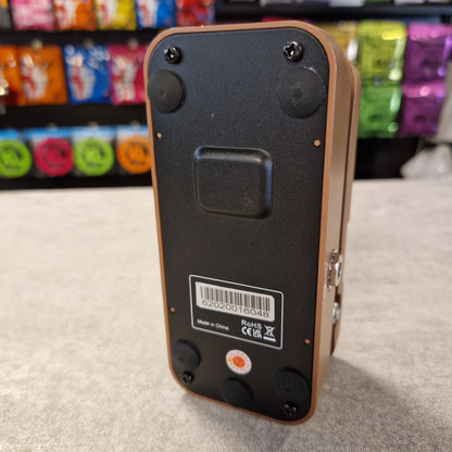 Pre-Owned Sonicake Back view of a small electronic device with a label on a grey surface.