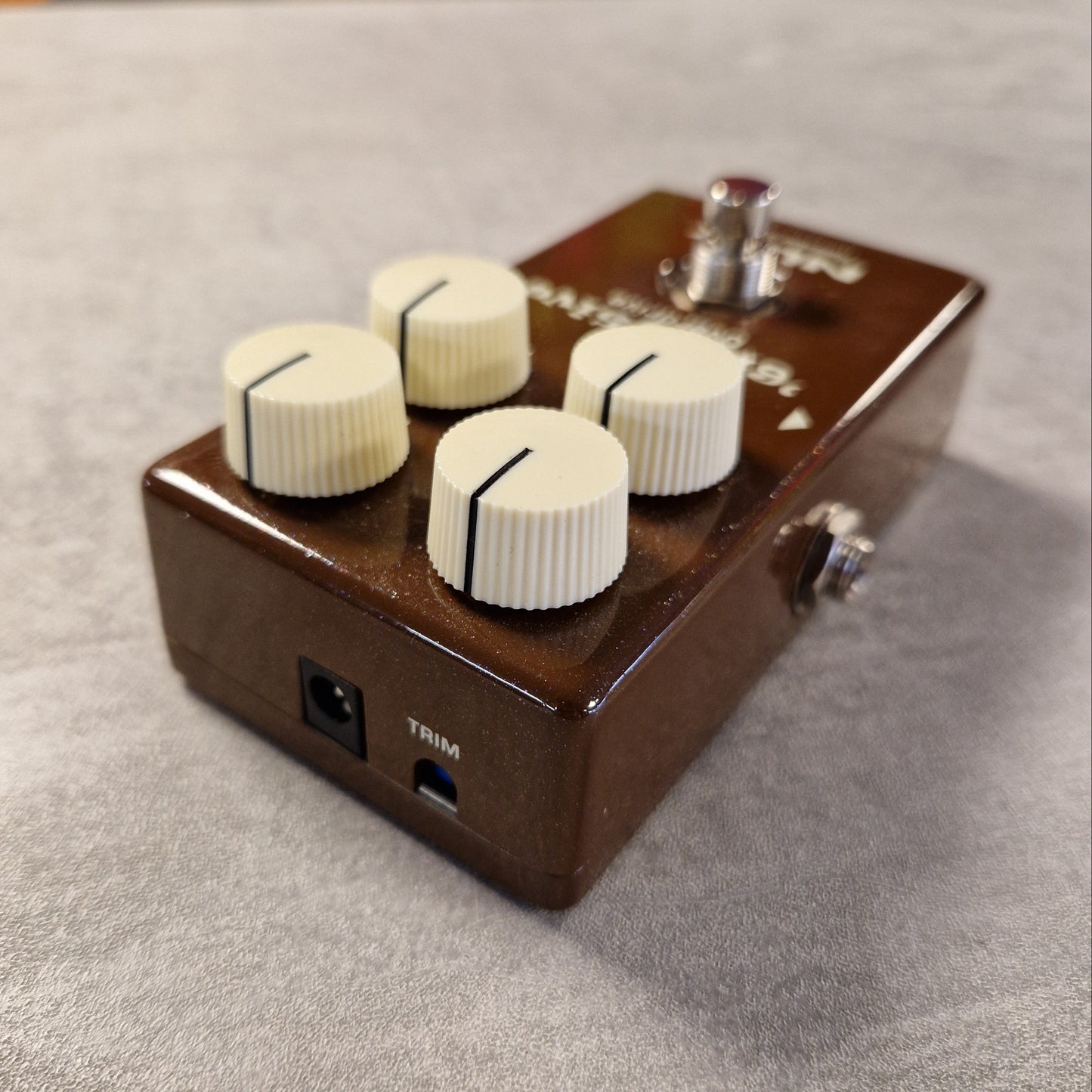 Pre-Owned NUX Guitar effects pedal with three knobs on a textured surface