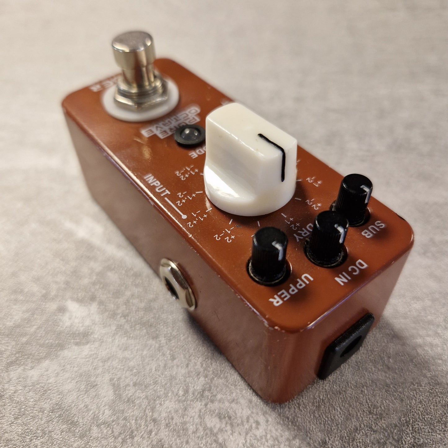 Pre-Owned Mooer Guitar effects pedal with various controls on a textured surface