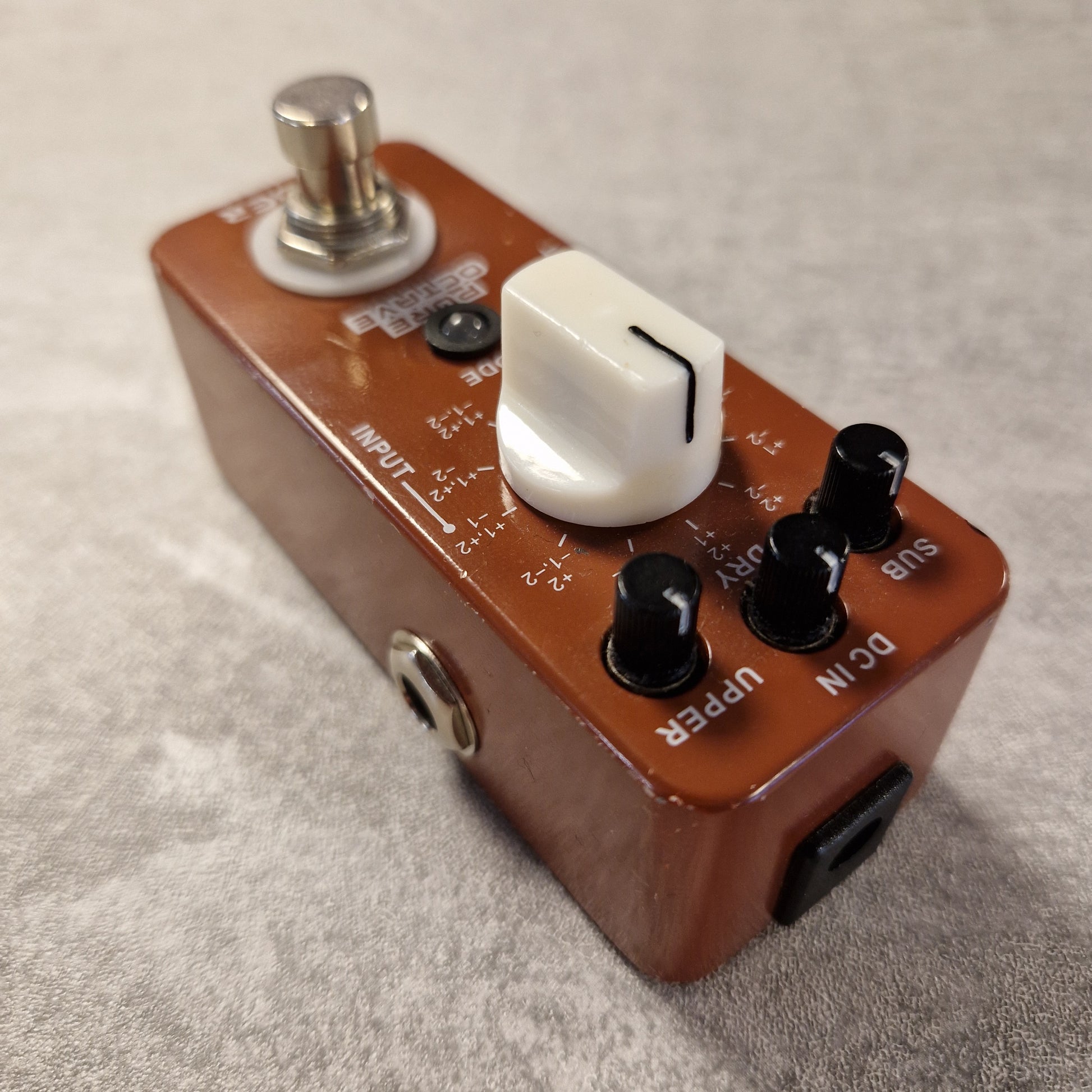 Pre-Owned Mooer Guitar effects pedal with various controls on a textured surface