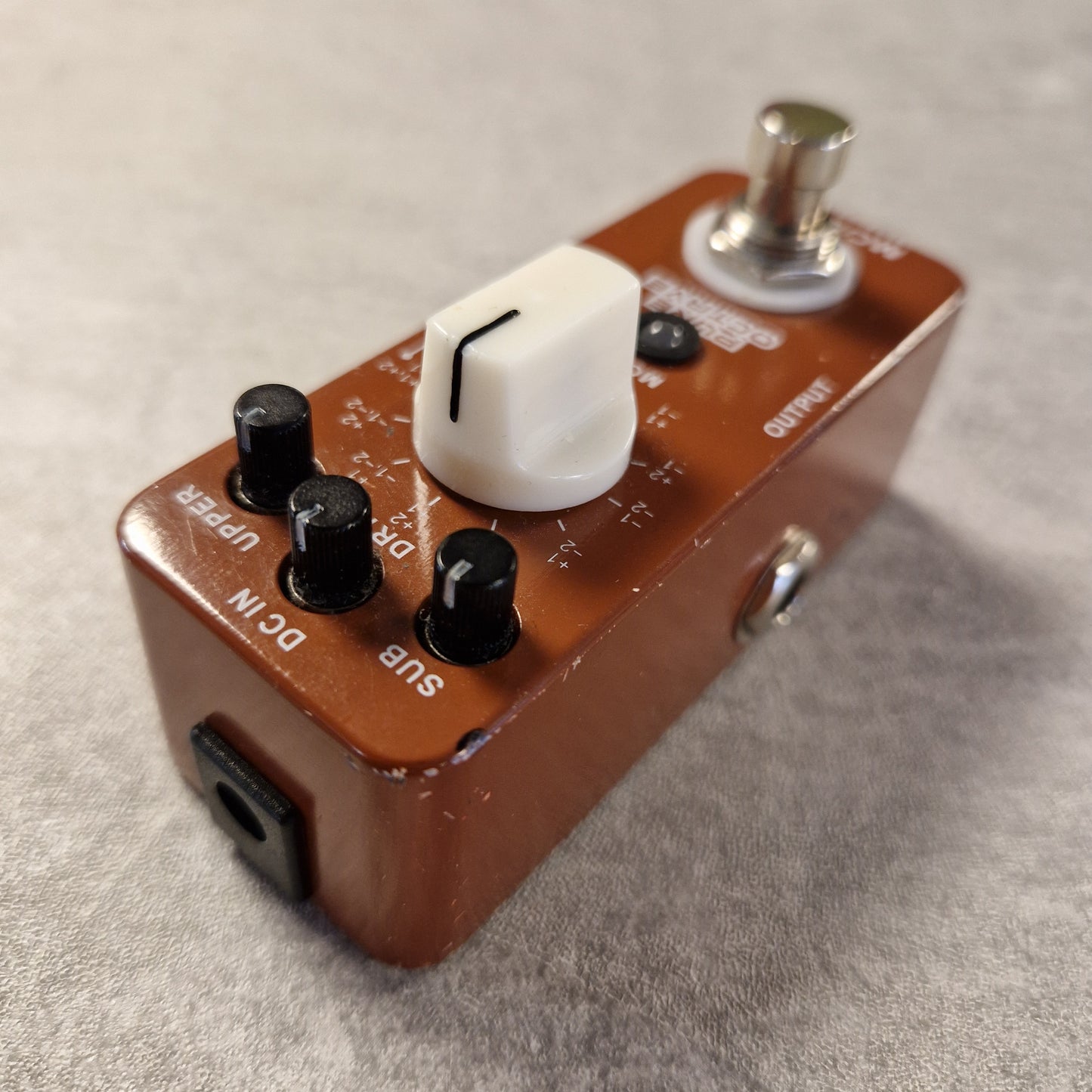 Pre-Owned Mooer Small brown electronic device with knobs and a switch on a grey surface